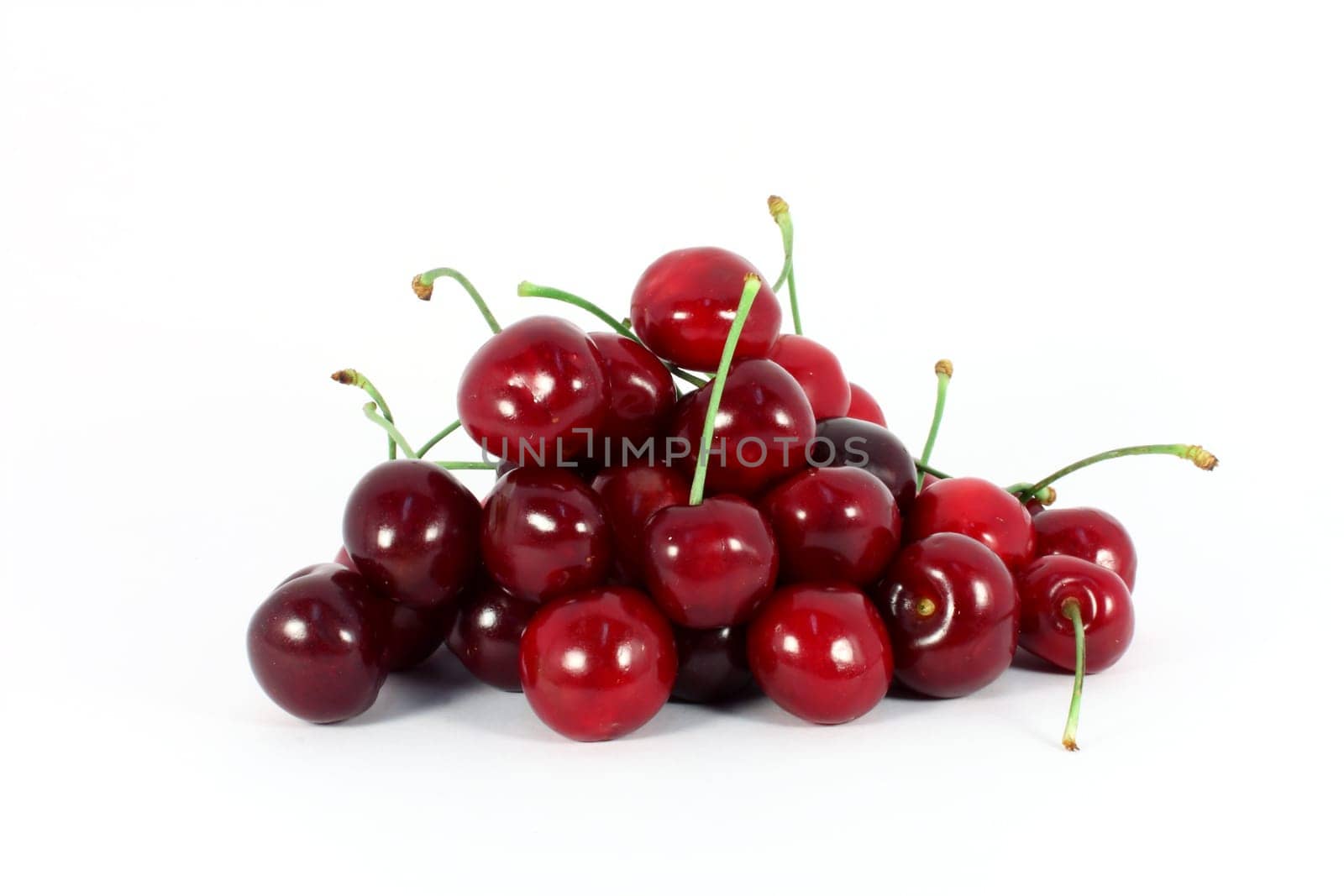 Heap of sweet cherries isolated on white