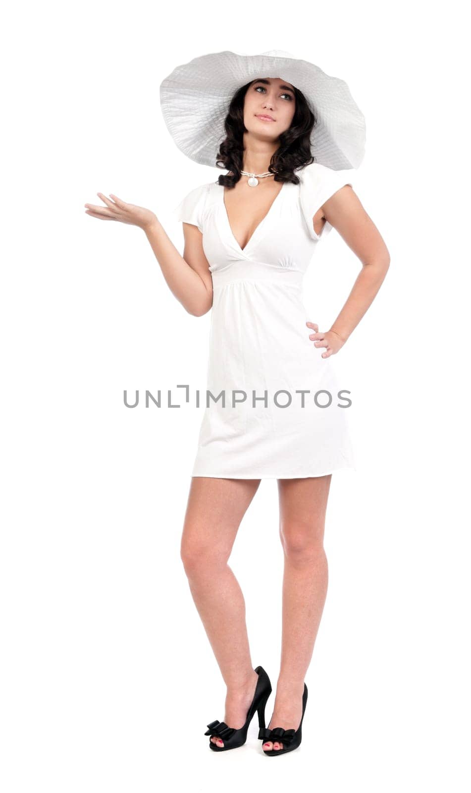 beautiful young fashion woman in white dress and hat with hand out