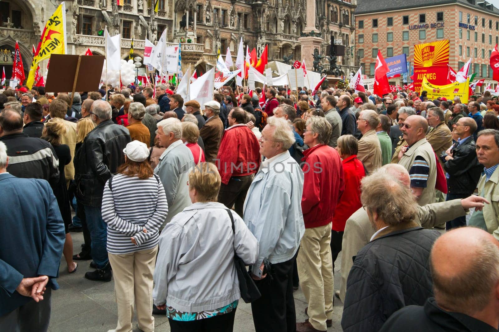 MUNICH,GERMANY - MAY 1st 2011: Many people participating in the rally at Munichs central Marienplatz in May Day,the international labour day,protesting against cuts in social welfare and low wages. May 1st,2011 in Munich,Germany.