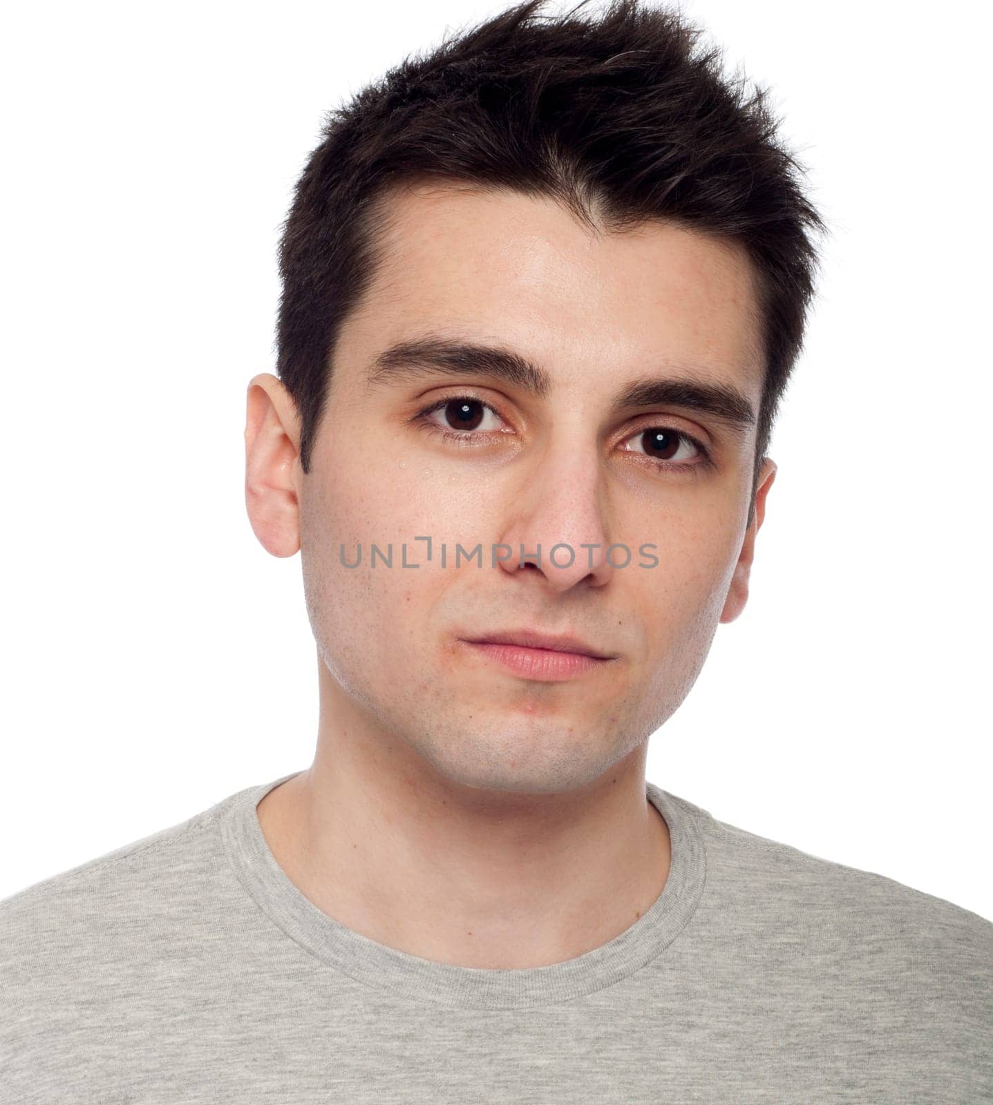 handsome young man with eye cream for dark circles below eye (isolated on white background)