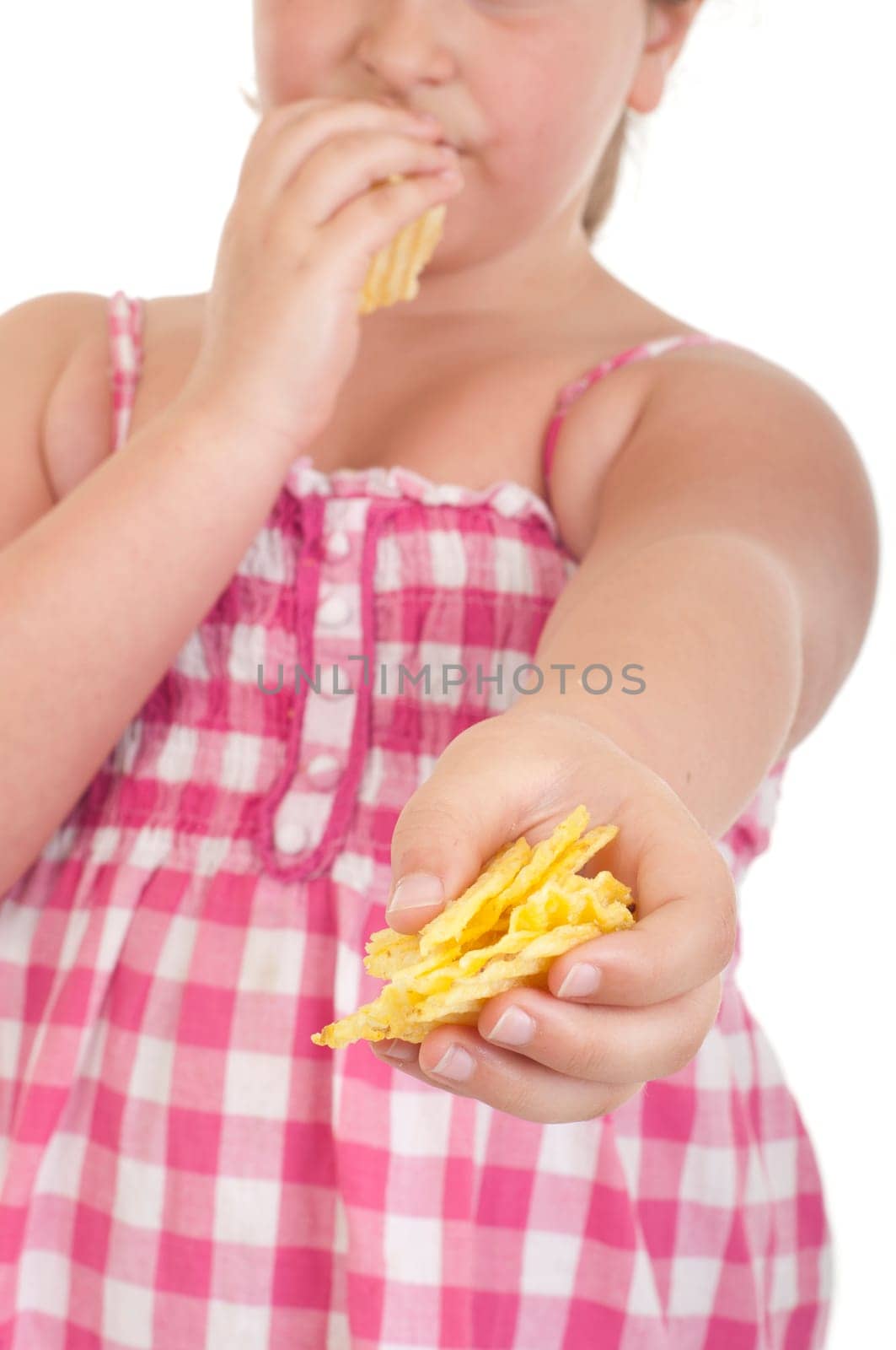 cute little girl eating chips and offering some too (isolated on white background)