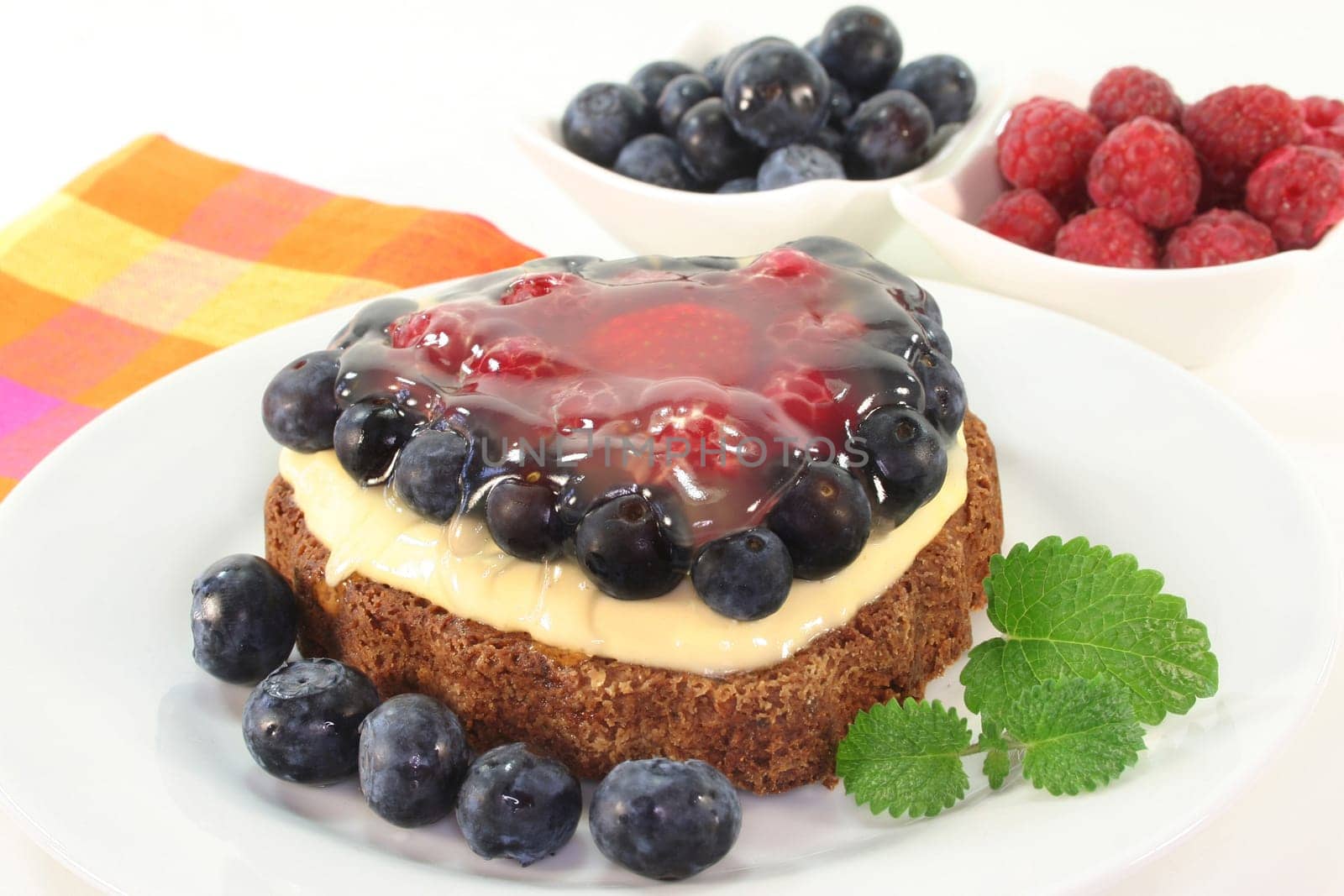 a forest fruit tart on a cake server