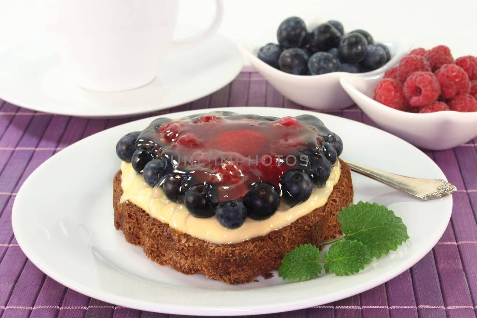 a forest fruit tart on a cake server