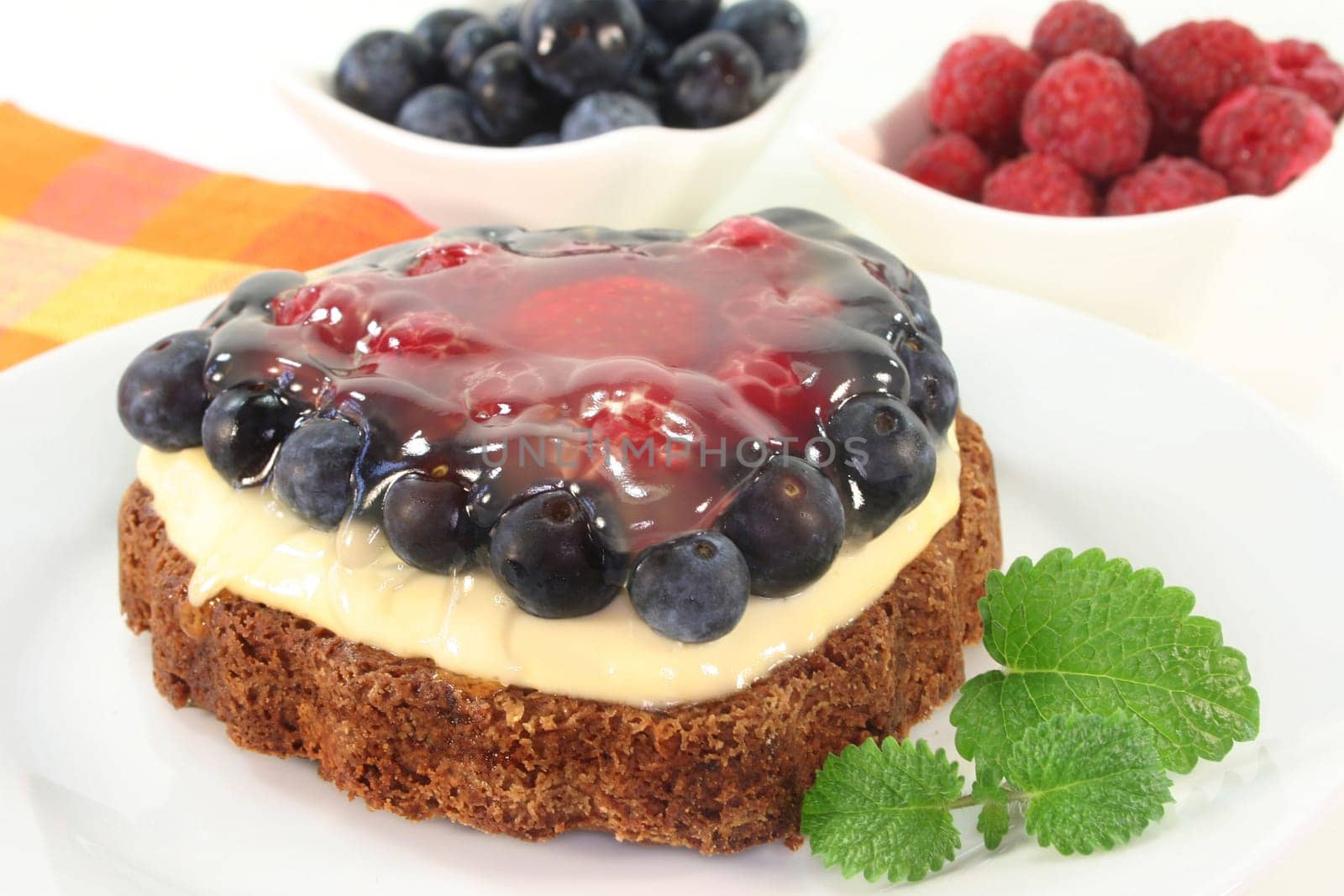 a forest fruit tart on a cake server