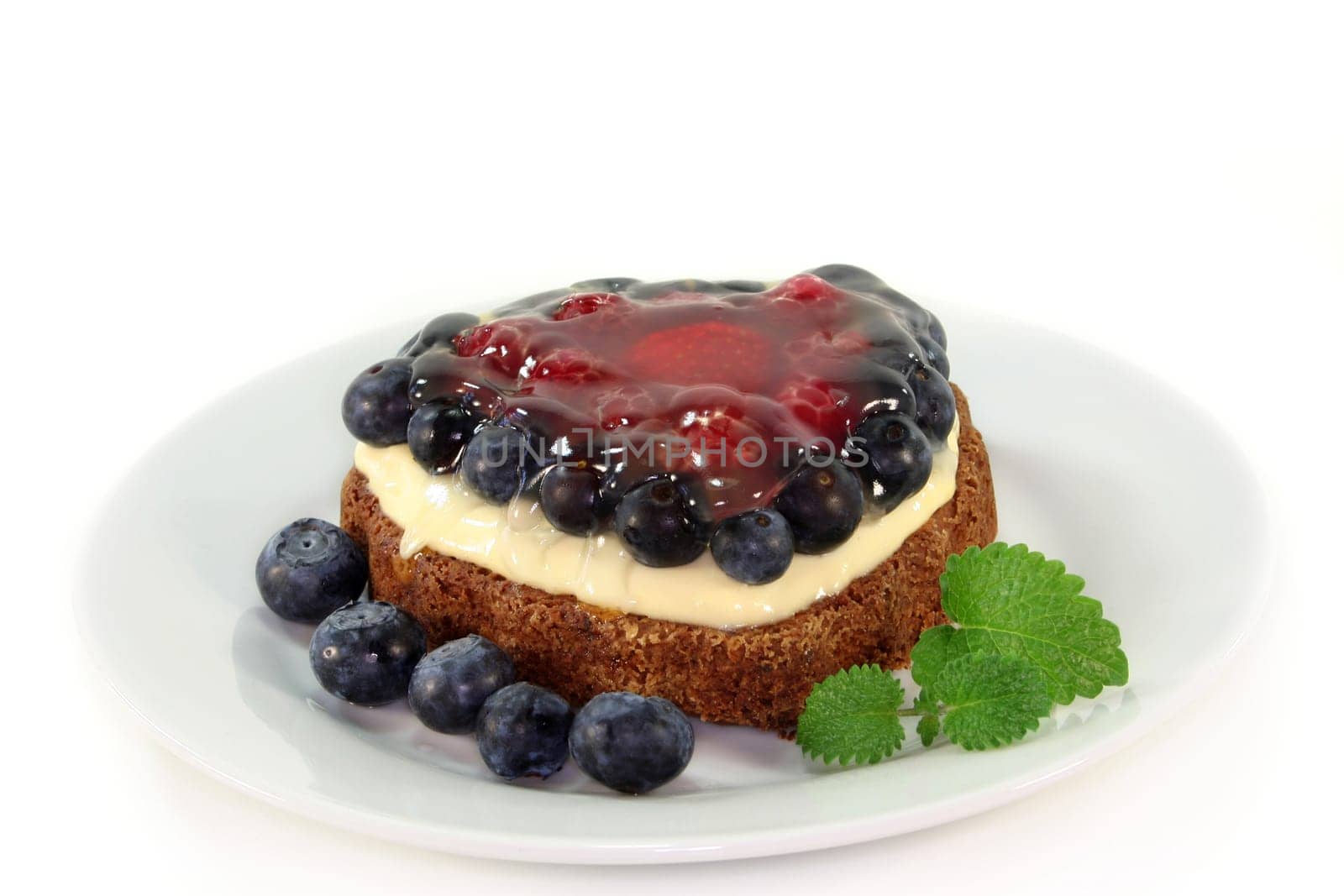 a forest fruit tart on a cake server