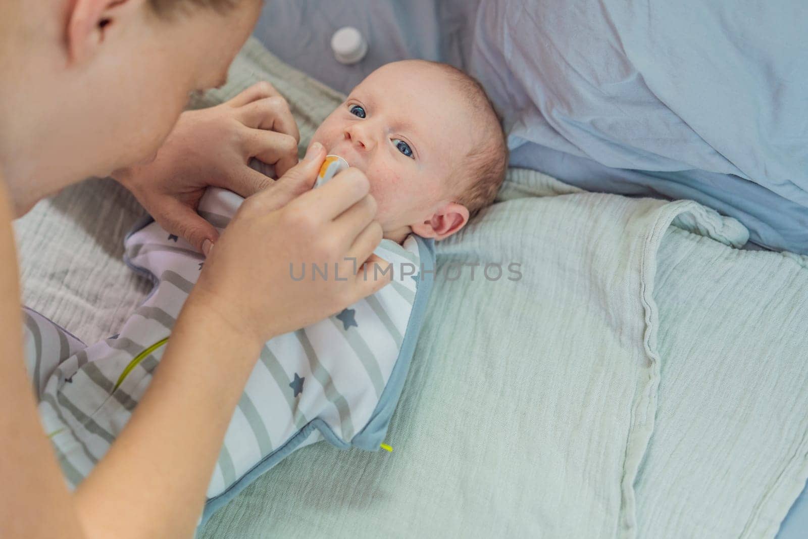 A mother carefully gives her newborn baby colic drops, ensuring comfort and relief. A tender moment of caregiving, love, and parental responsibility, symbolizing infant care and maternal dedication.