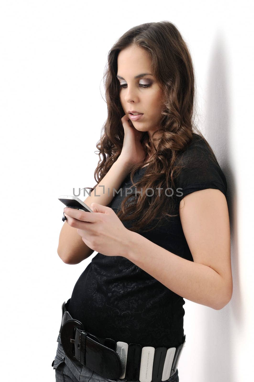 Young woman using mobile phone on white background