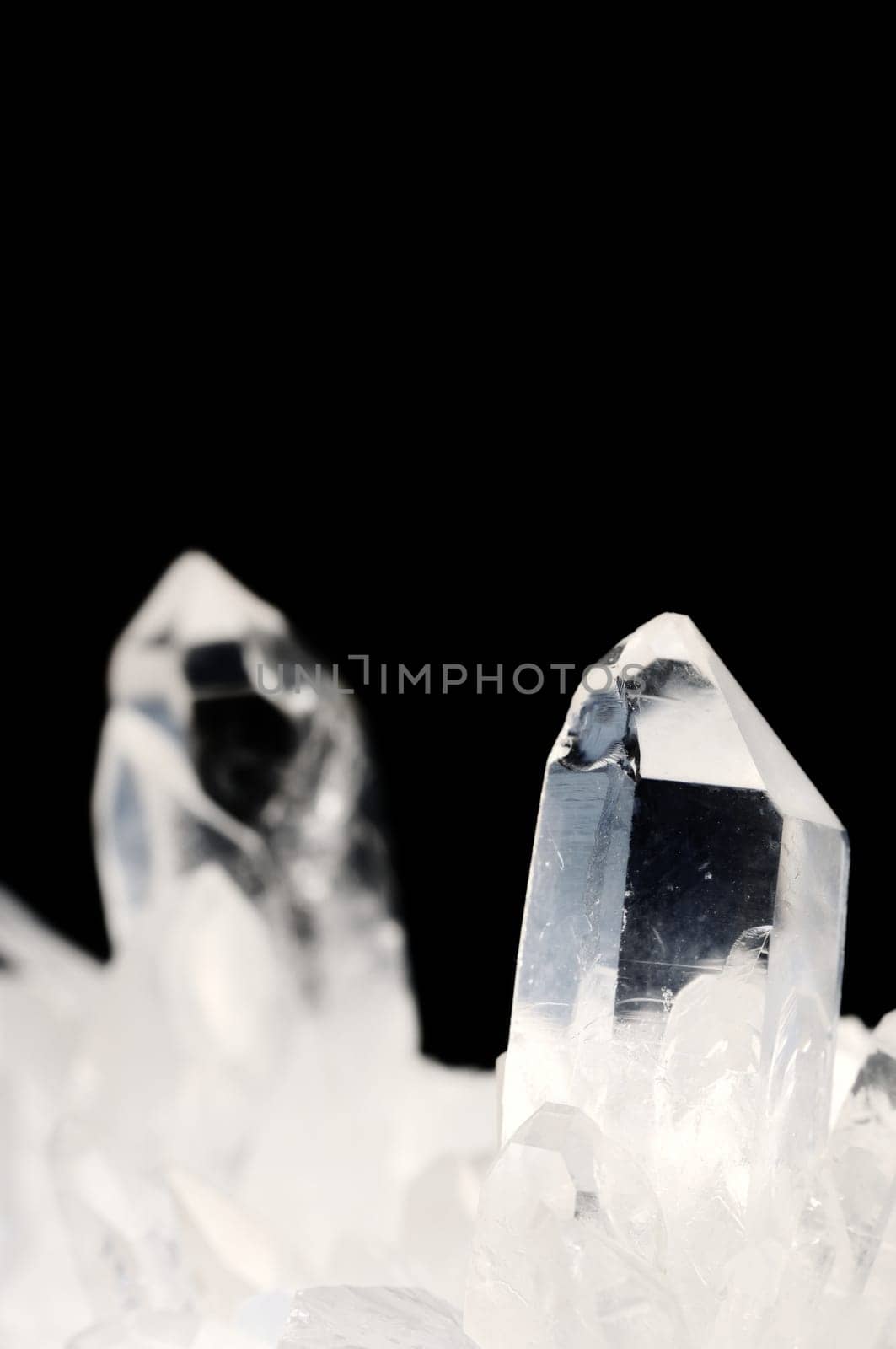 Quartz crystals on black background with copy space