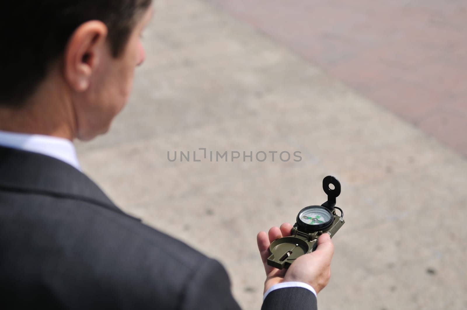 Senior people series - portrait of mature business man looking at compass with copy space