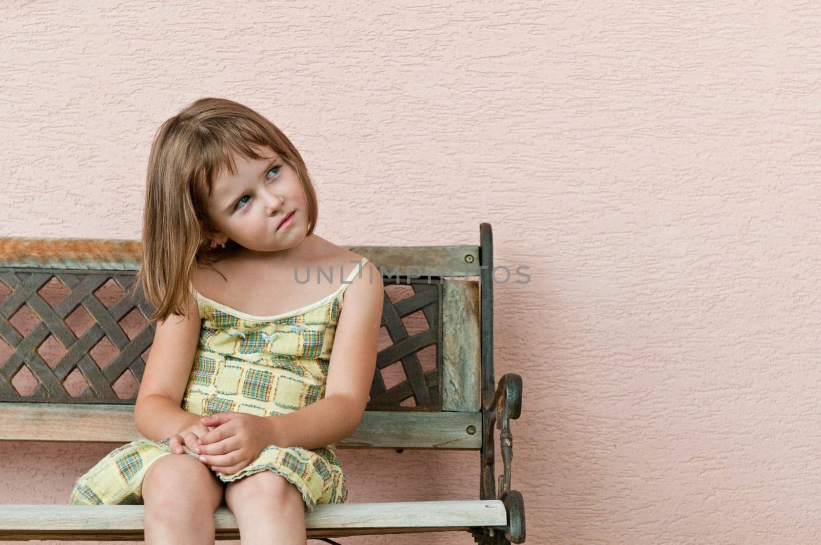 Outdoors portrait of small cute child looking to side with copy space