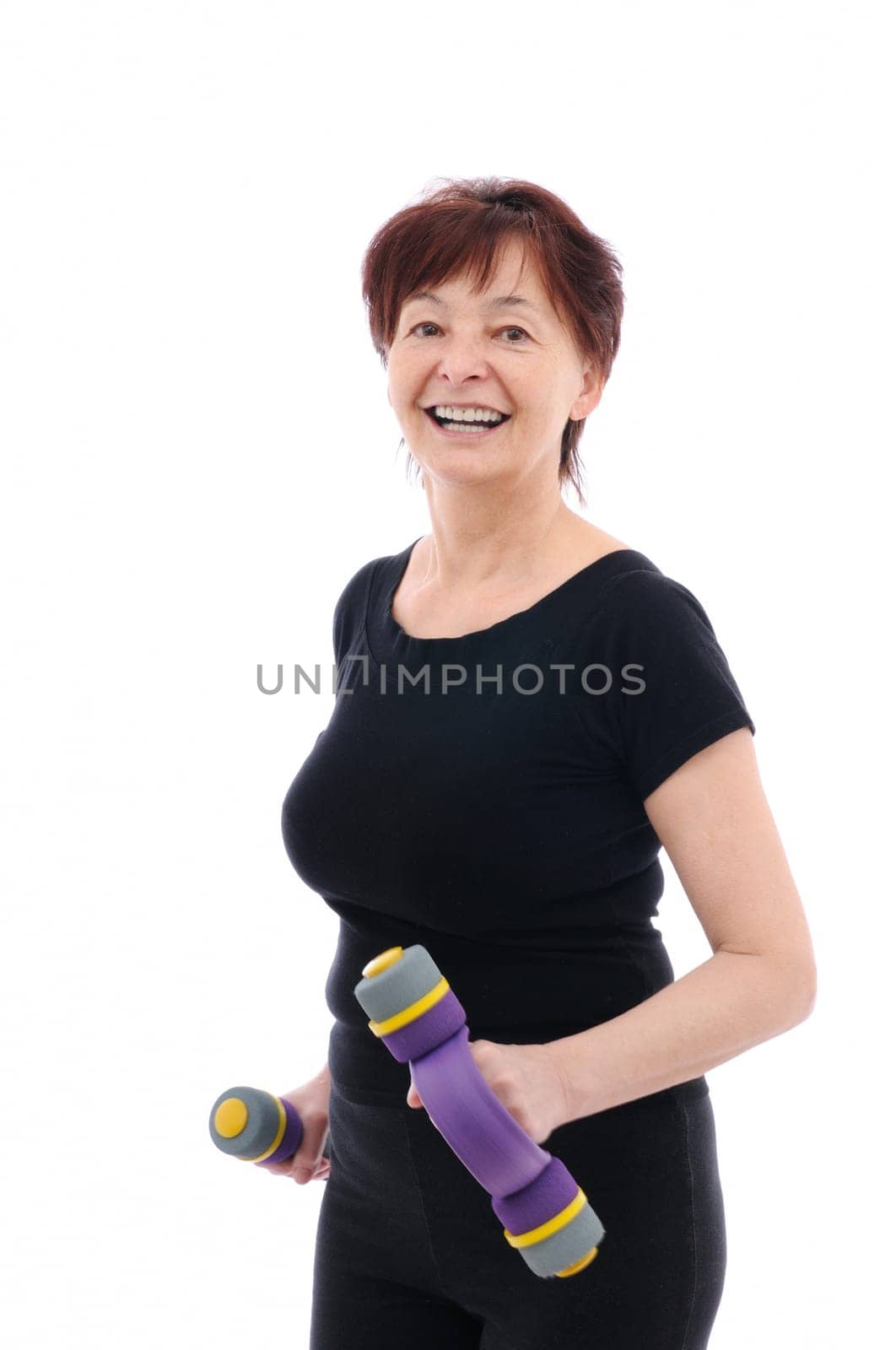 Smiling senior fitness woman with barbells