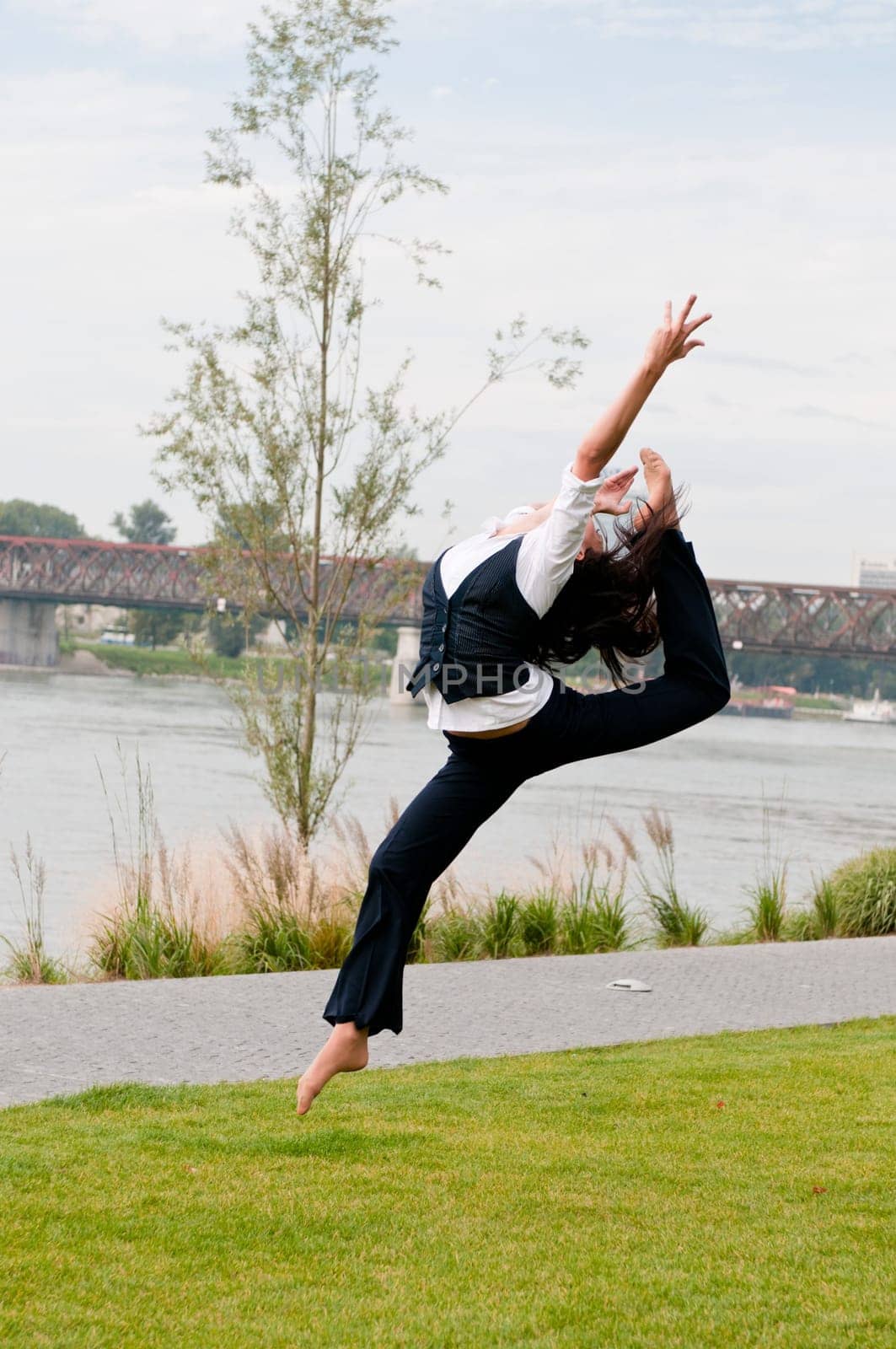 Woman in gymnastics jump outdoors