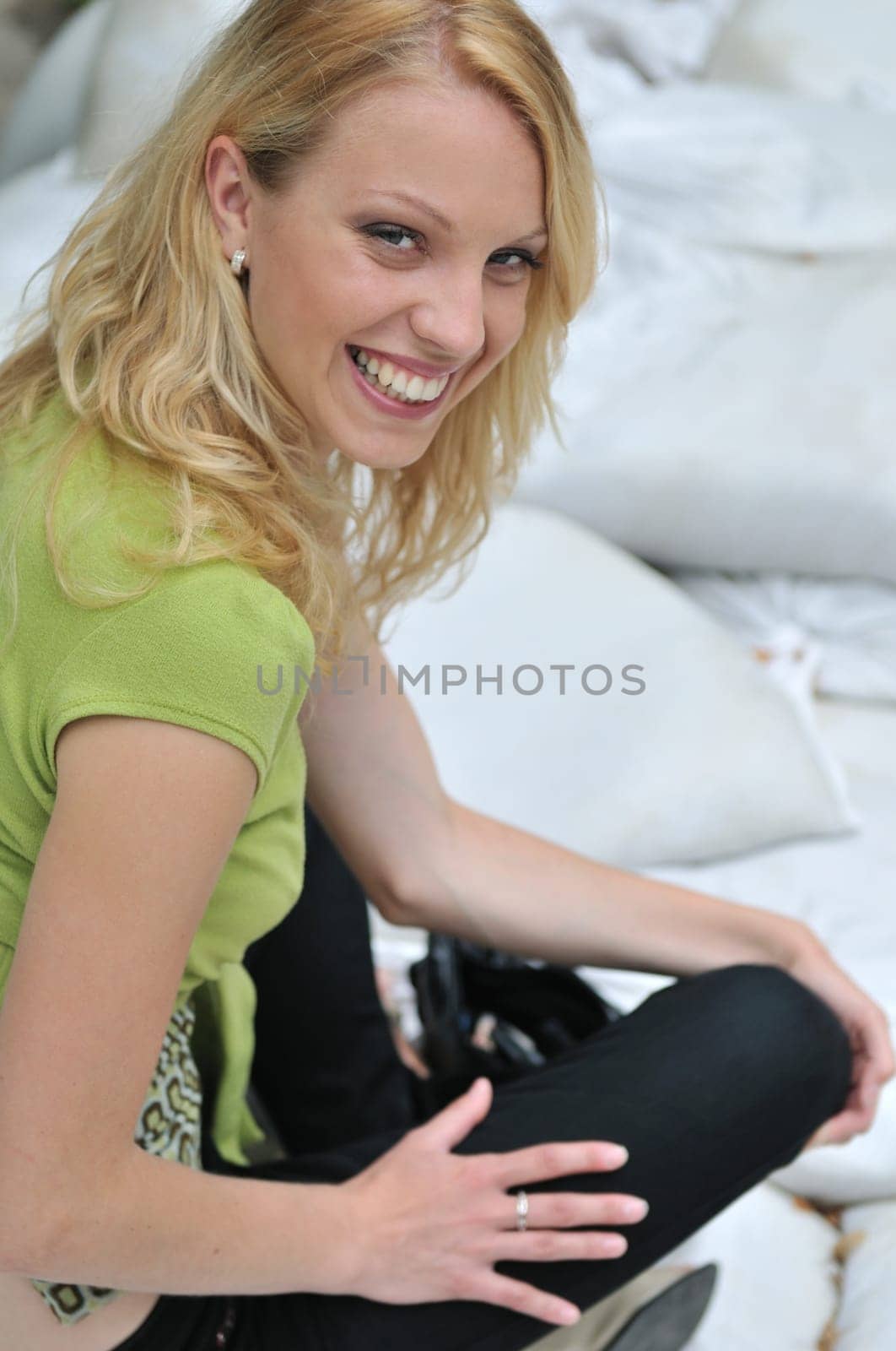 Young beautiful smiling woman siting outside