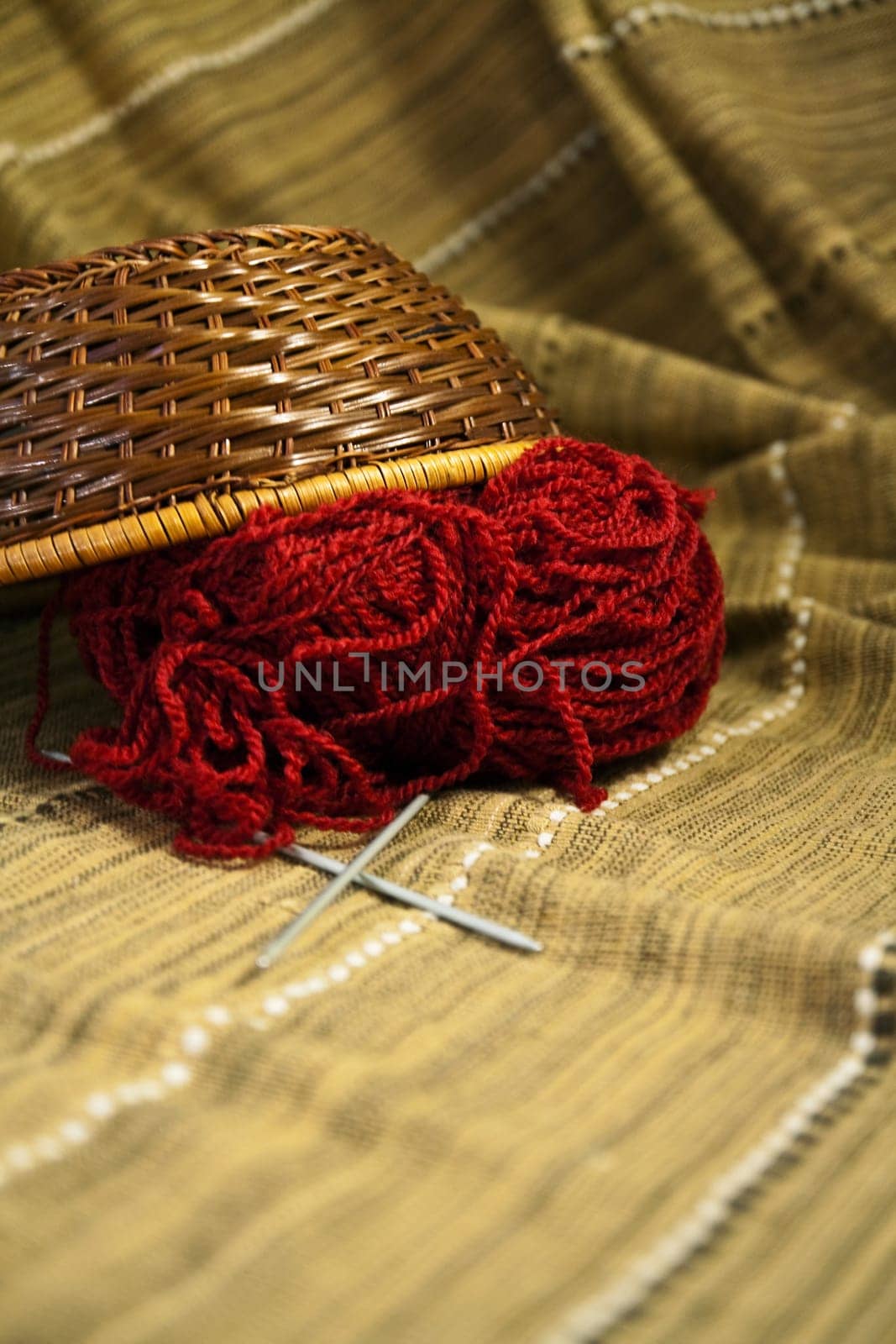 Balls of colored yarn for hand knitting in a decorative basket