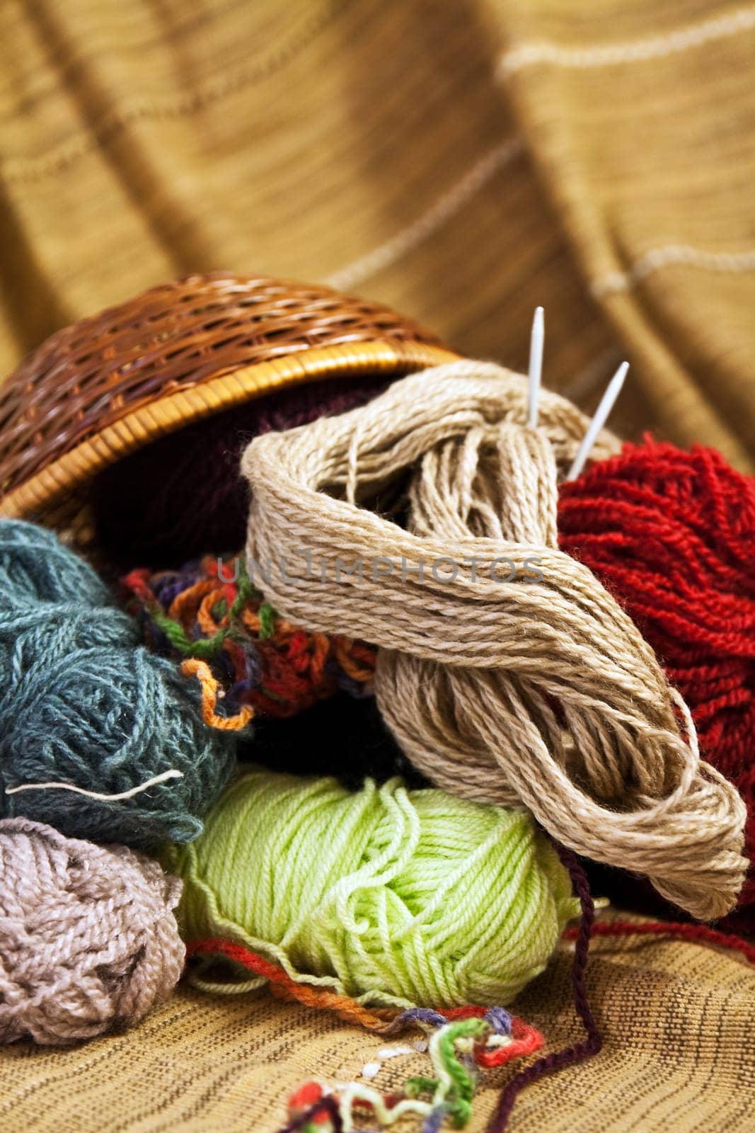 Balls of colored yarn for hand knitting in a decorative basket