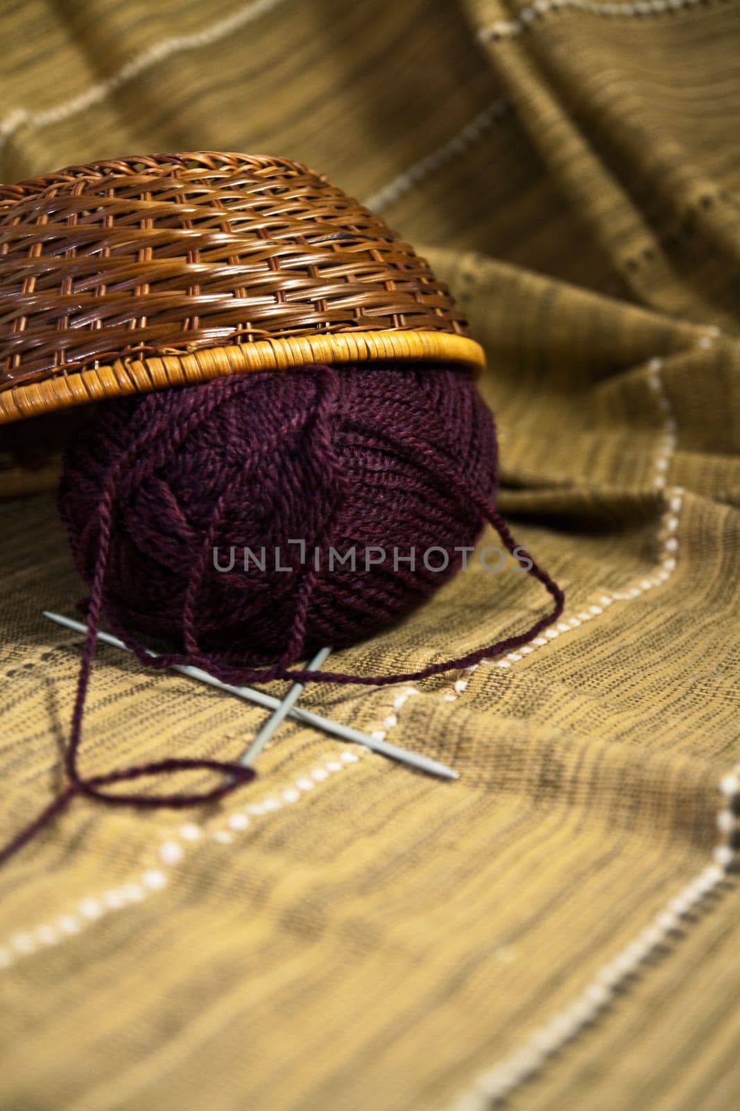 Balls of colored yarn for hand knitting in a decorative basket