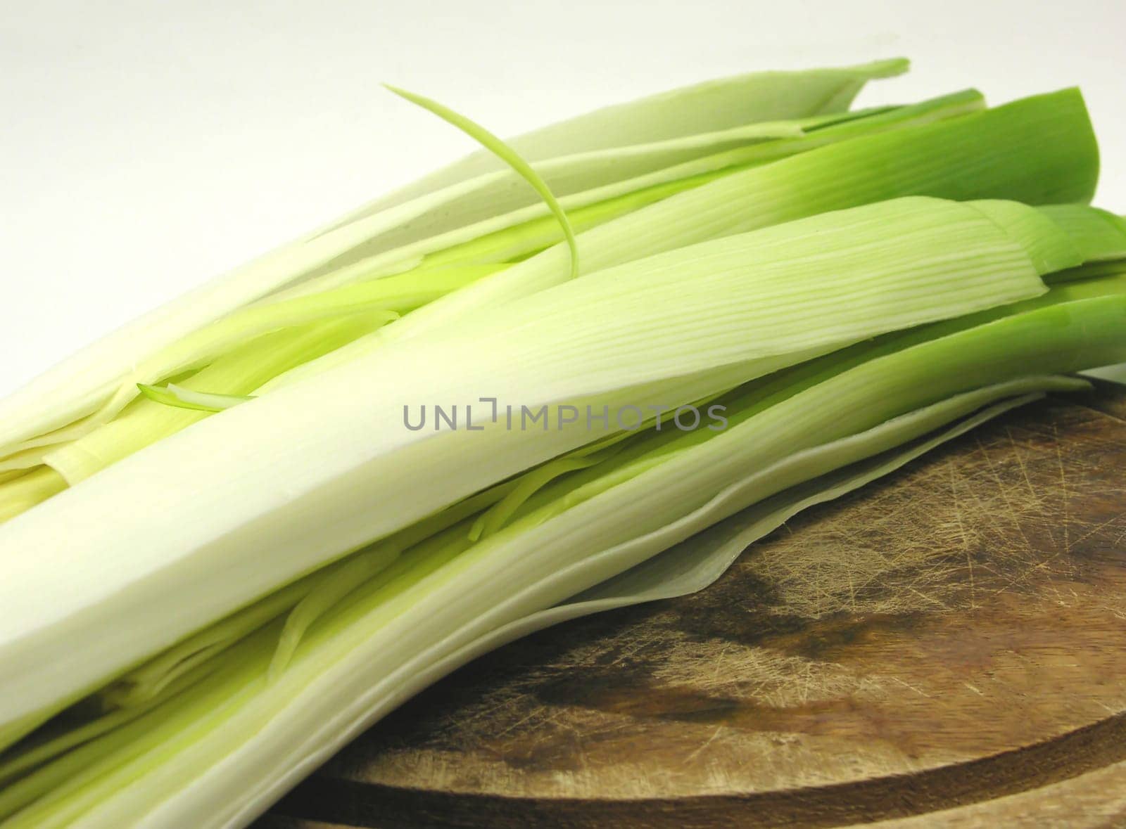 Leek sticks on wooden board in close-up