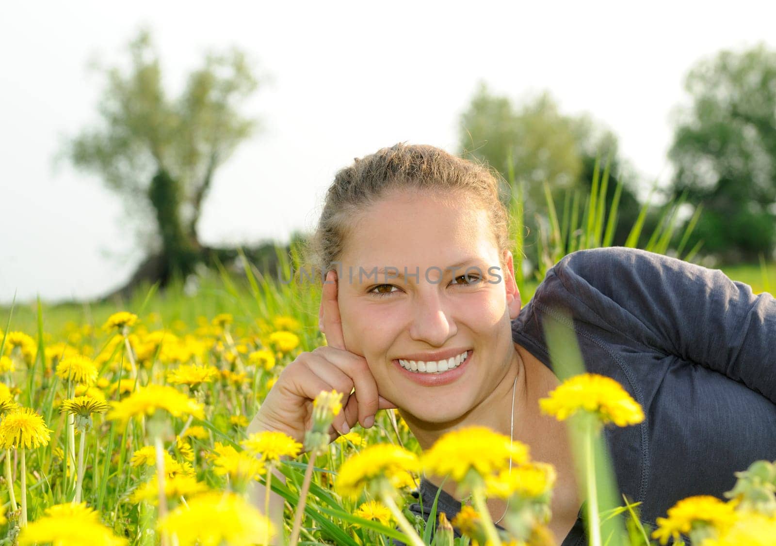 Young woman on a flower meadow