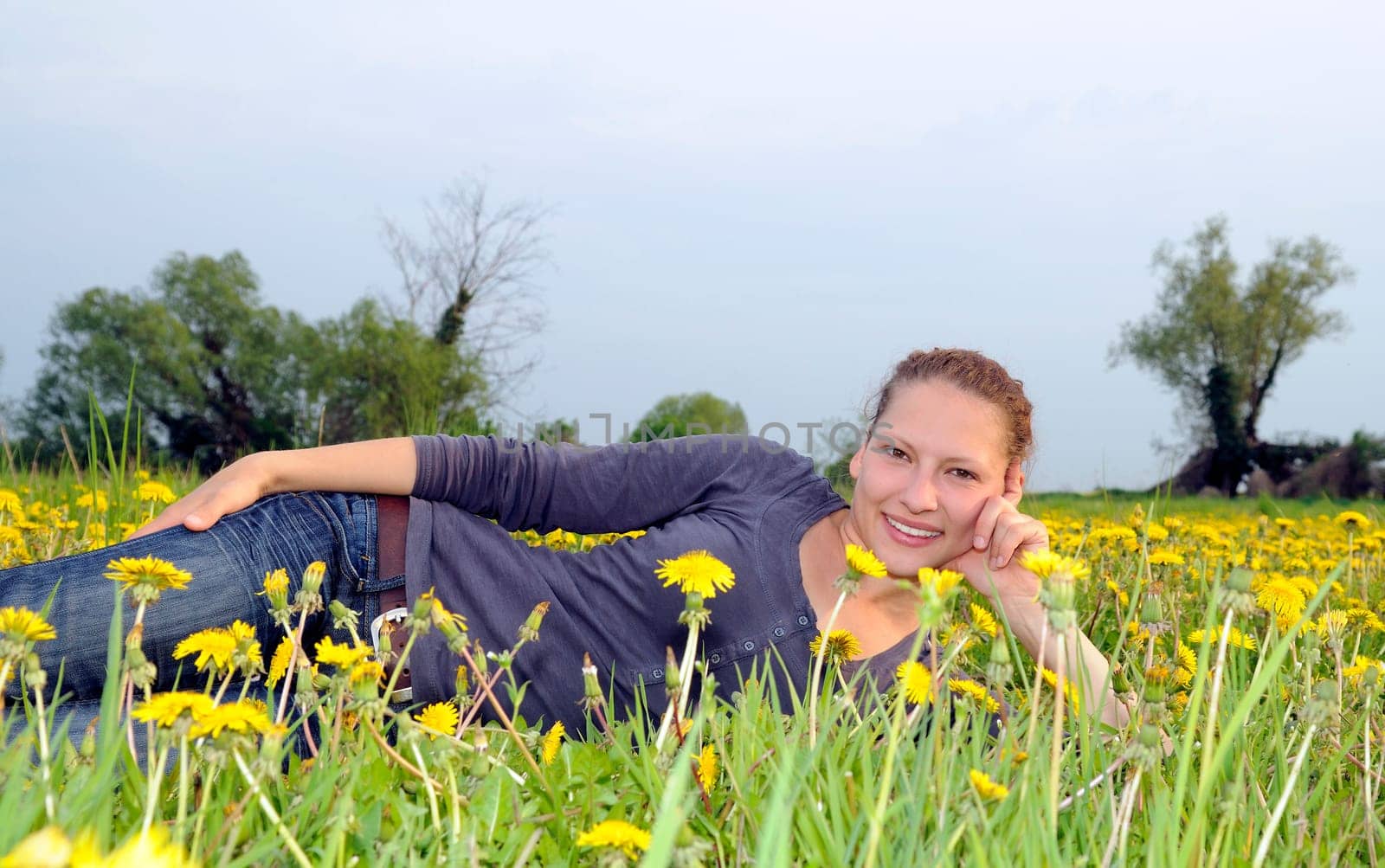 Young woman on a flower meadow