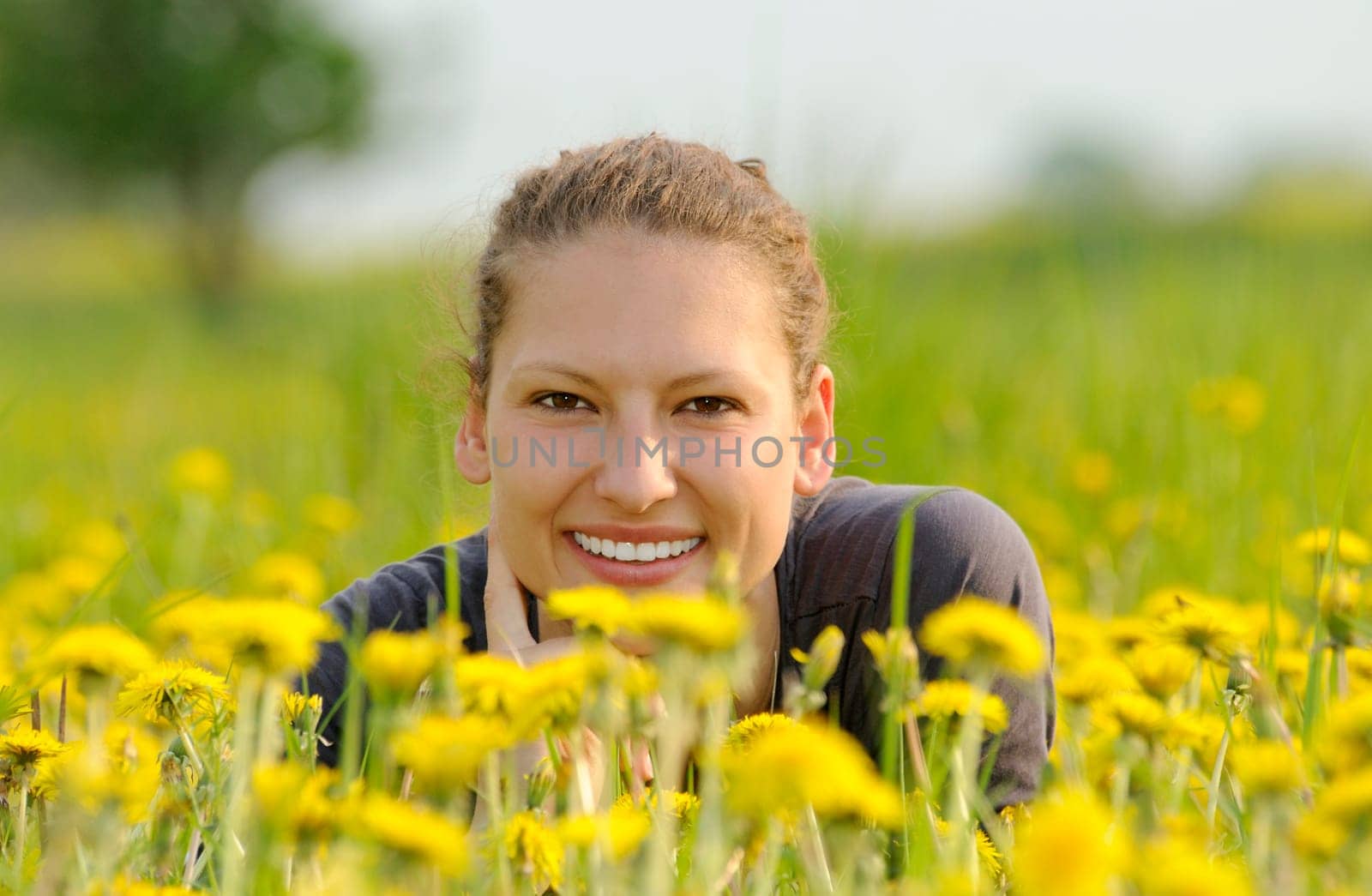 Young woman on a flower meadow