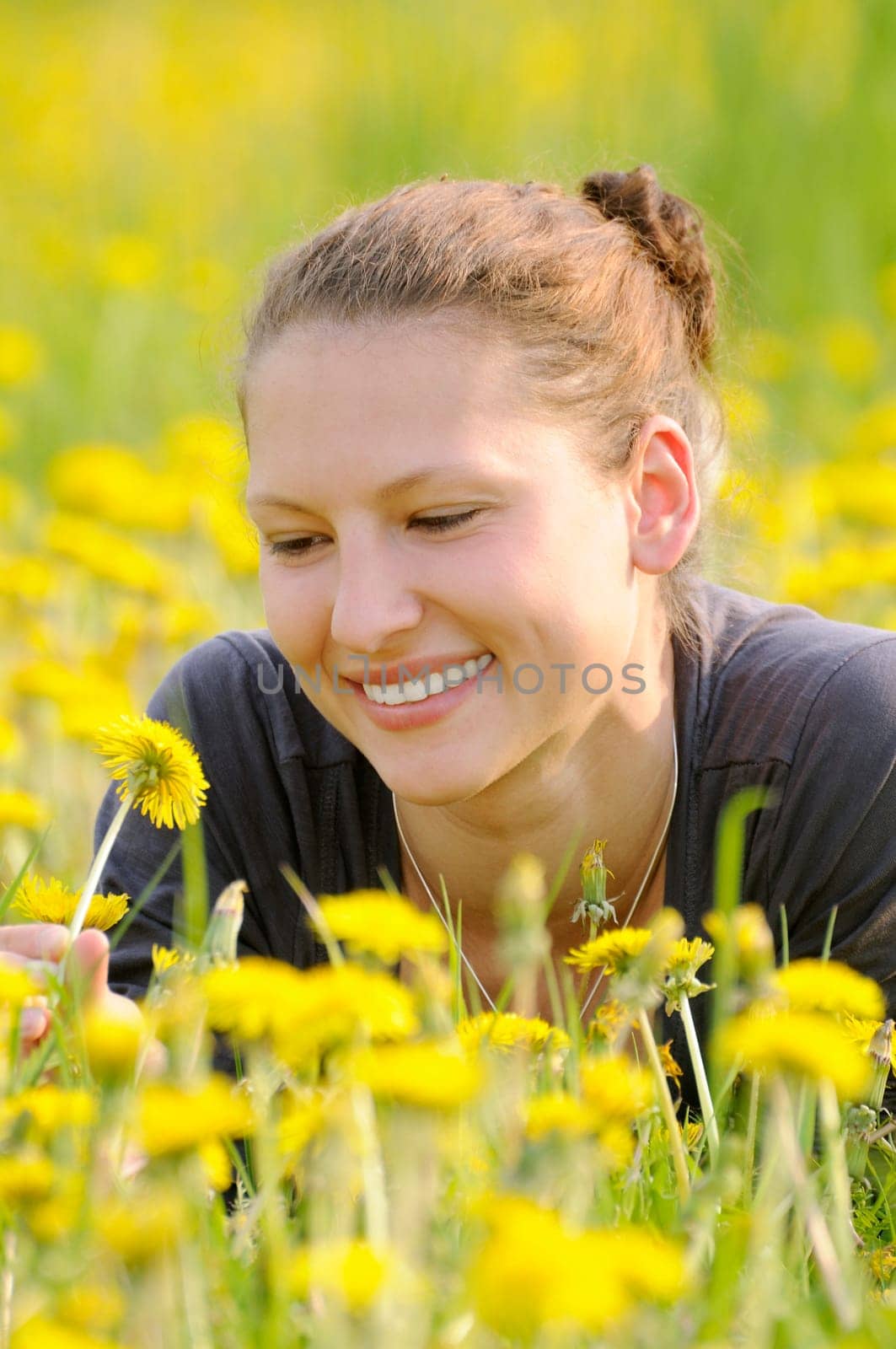 Young woman on a flower meadow