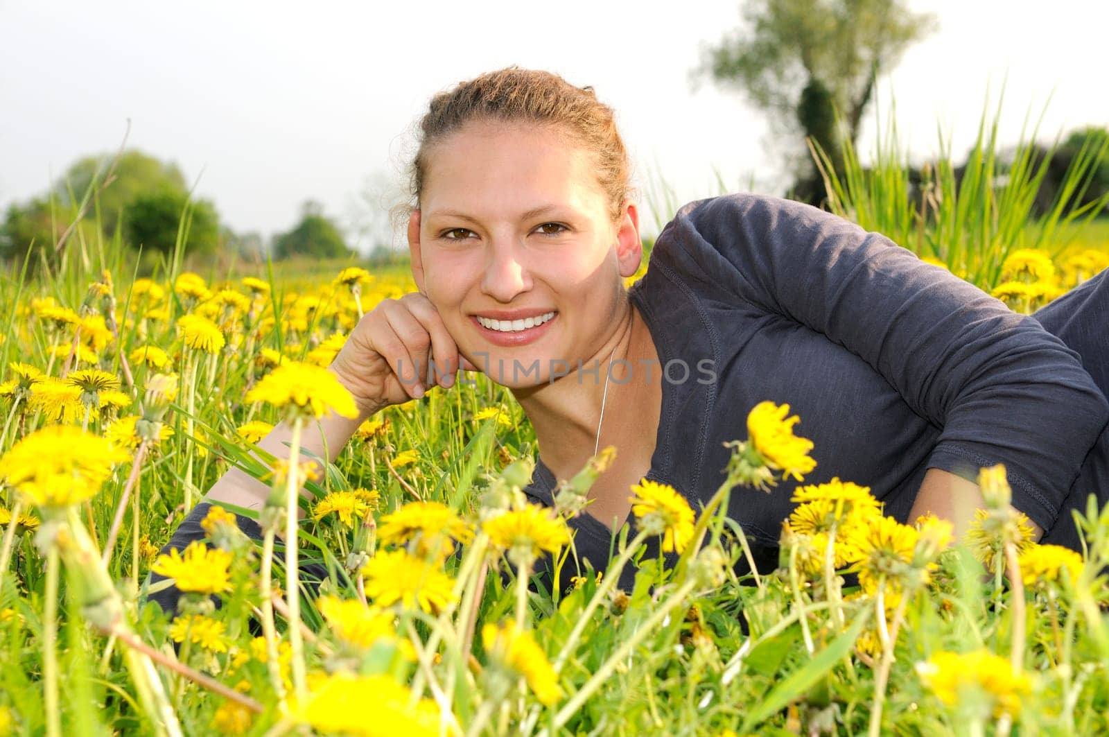 Young woman on a flower meadow