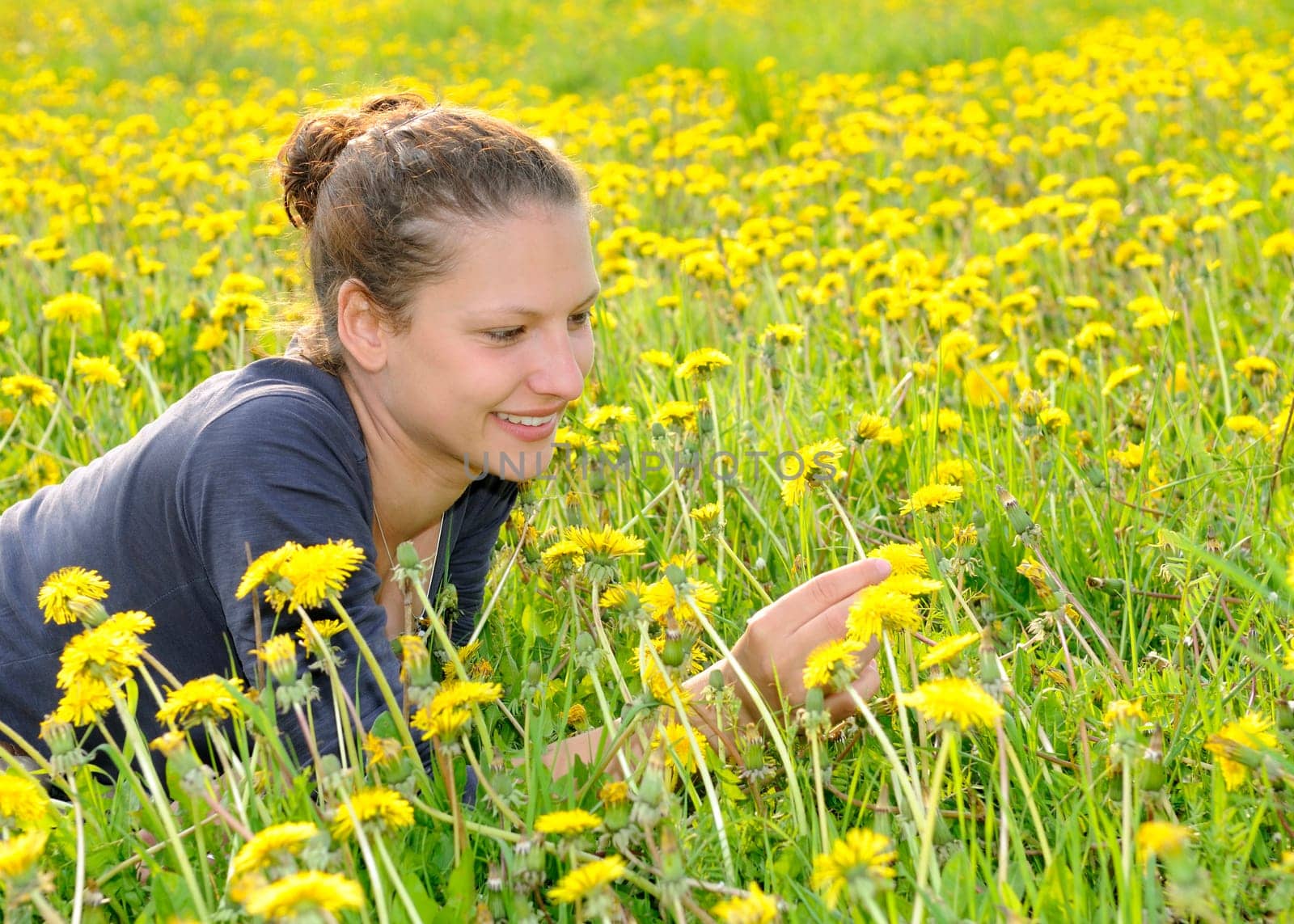 Young woman on a flower meadow