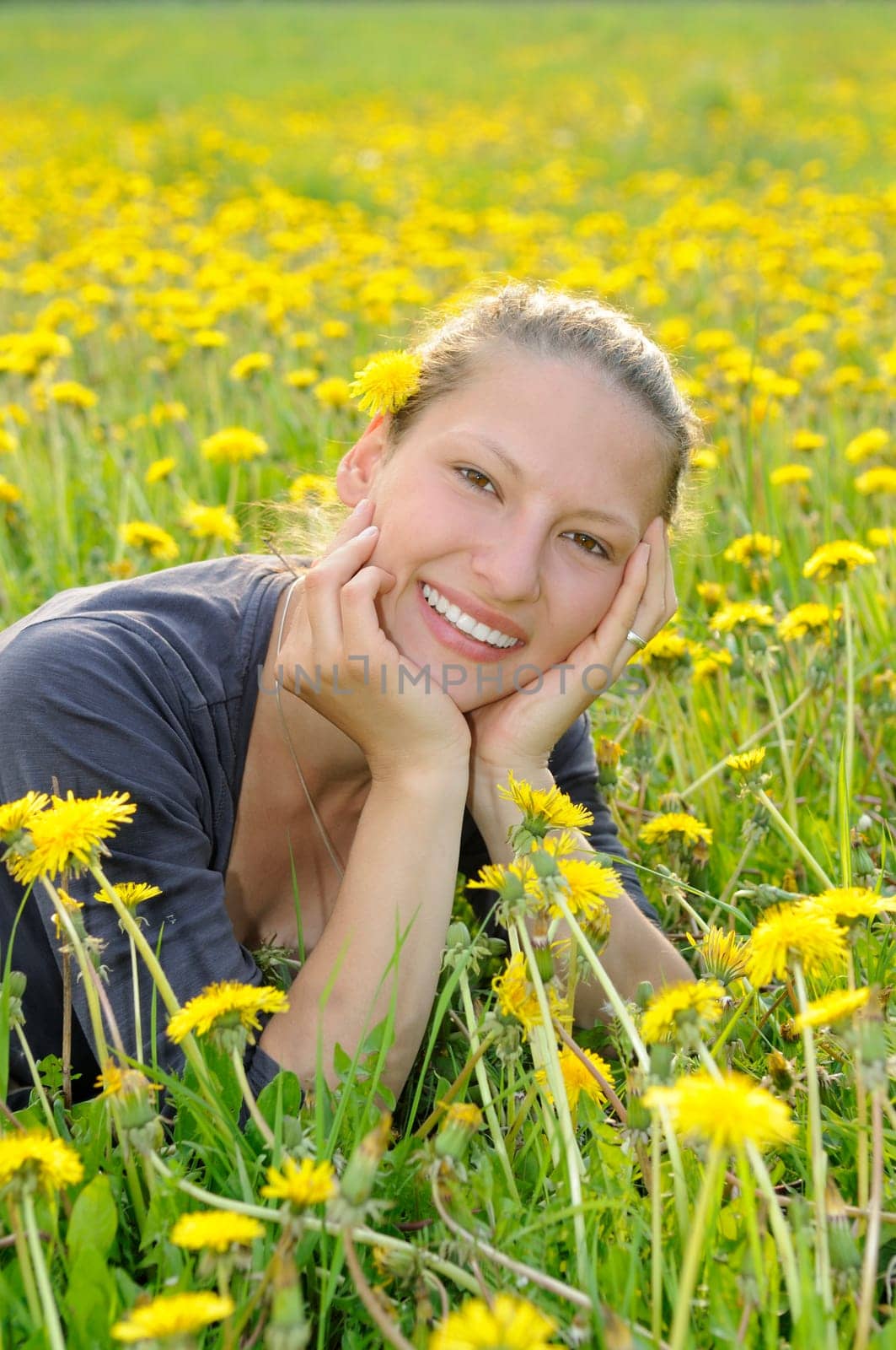 Young woman on a flower meadow