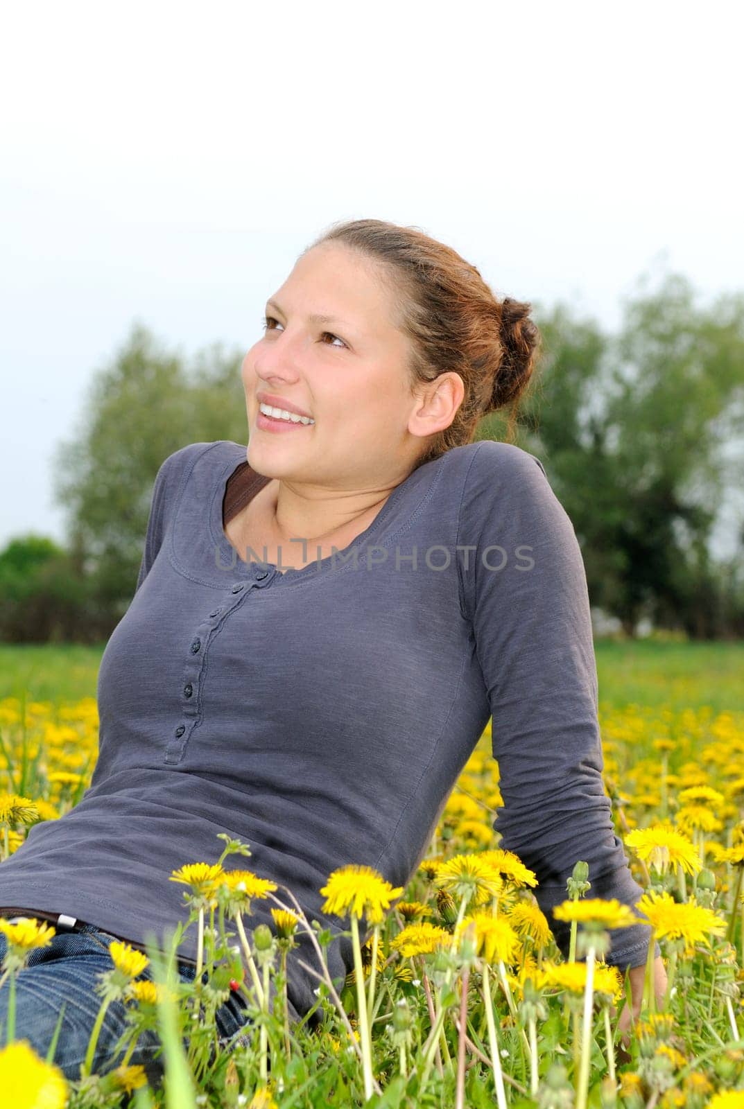 Young woman on a flower meadow