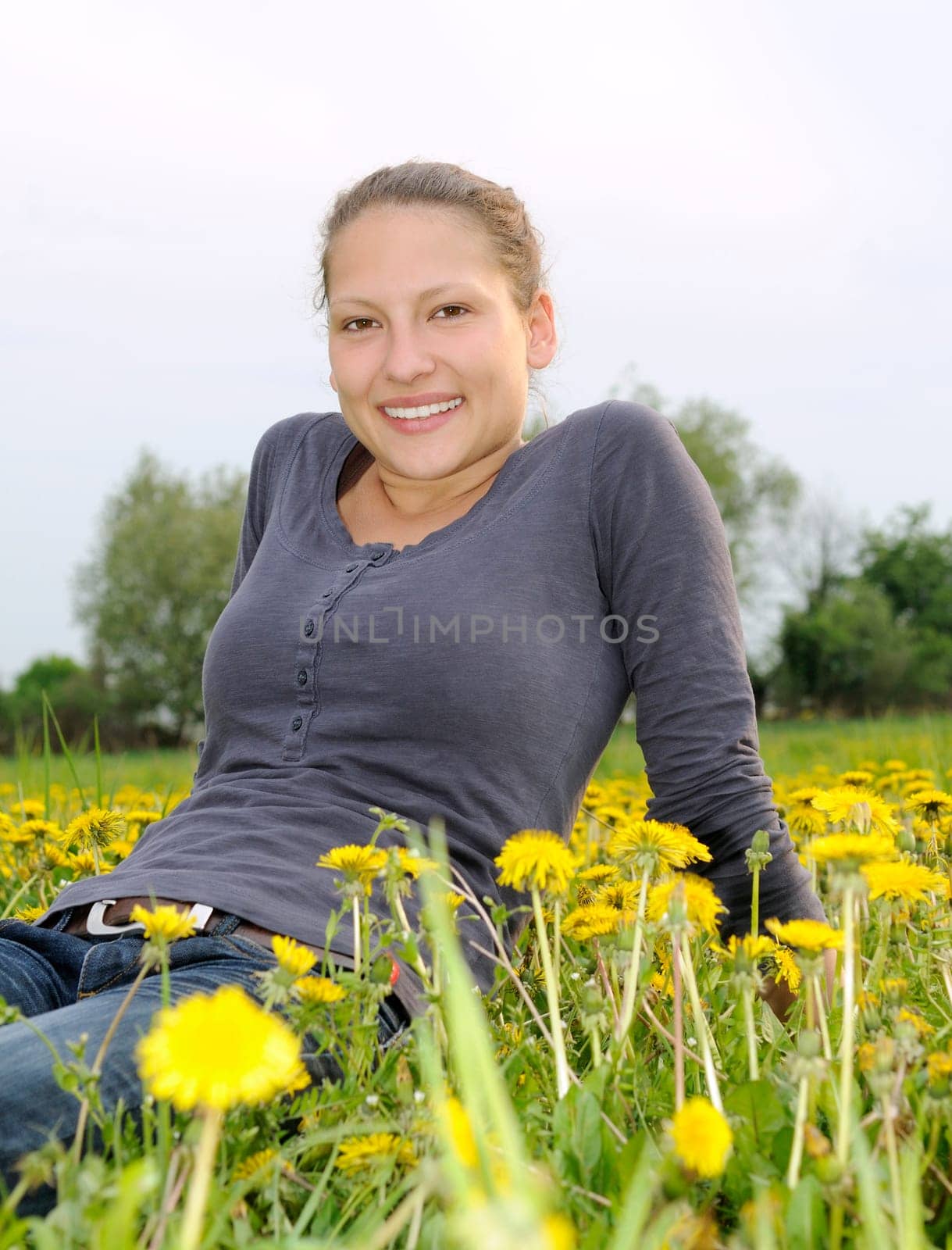 Young woman on a flower meadow