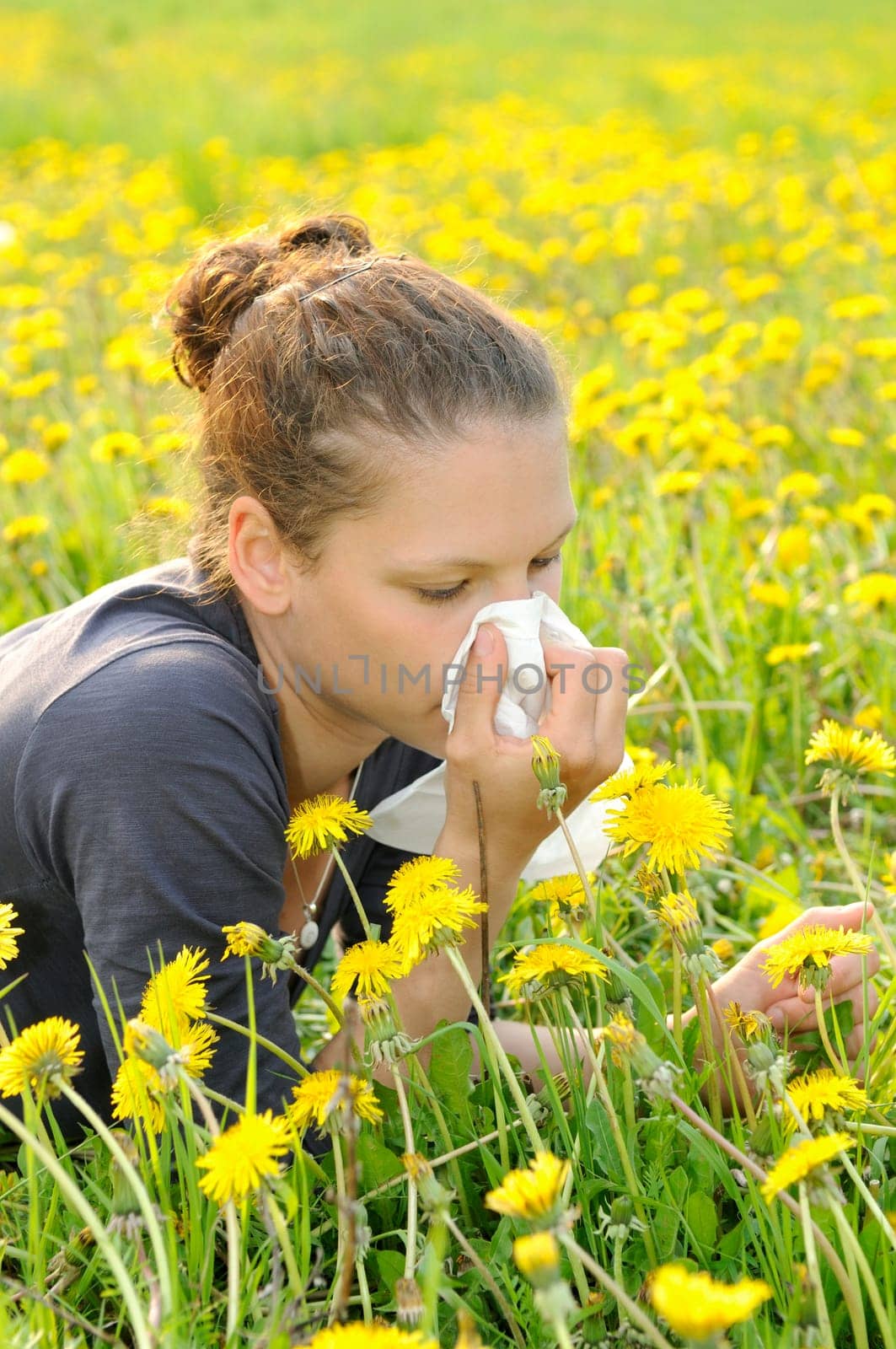 Young woman with handkerchief on a meadow