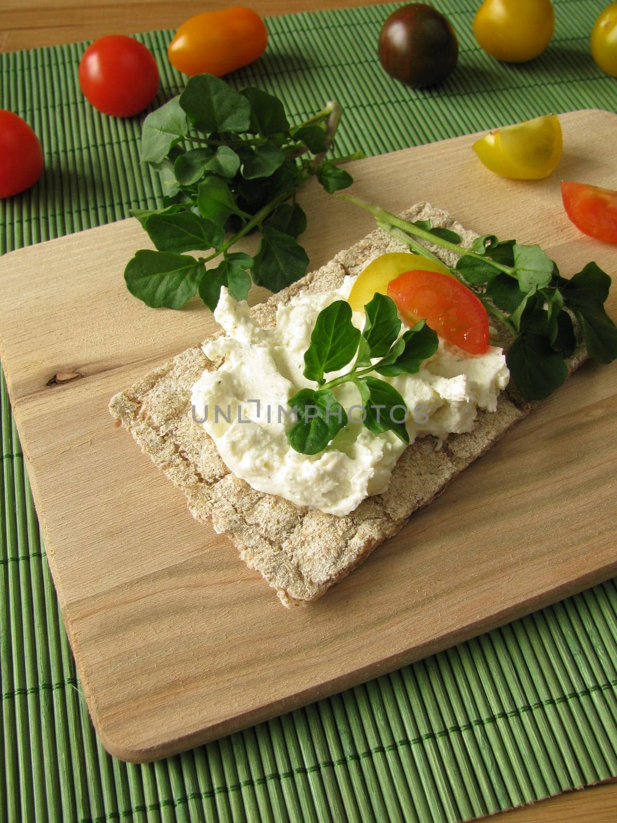 Cream cheese with watercress on crispbread
