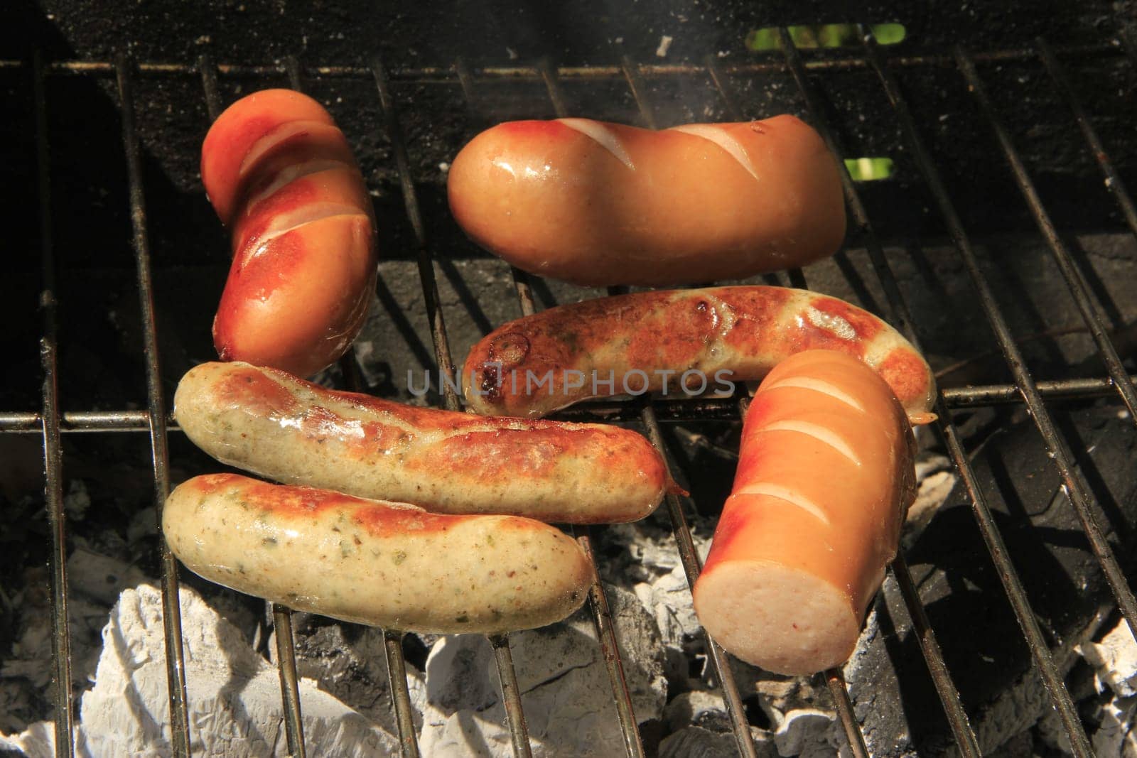 various sausages on the charcoal grill