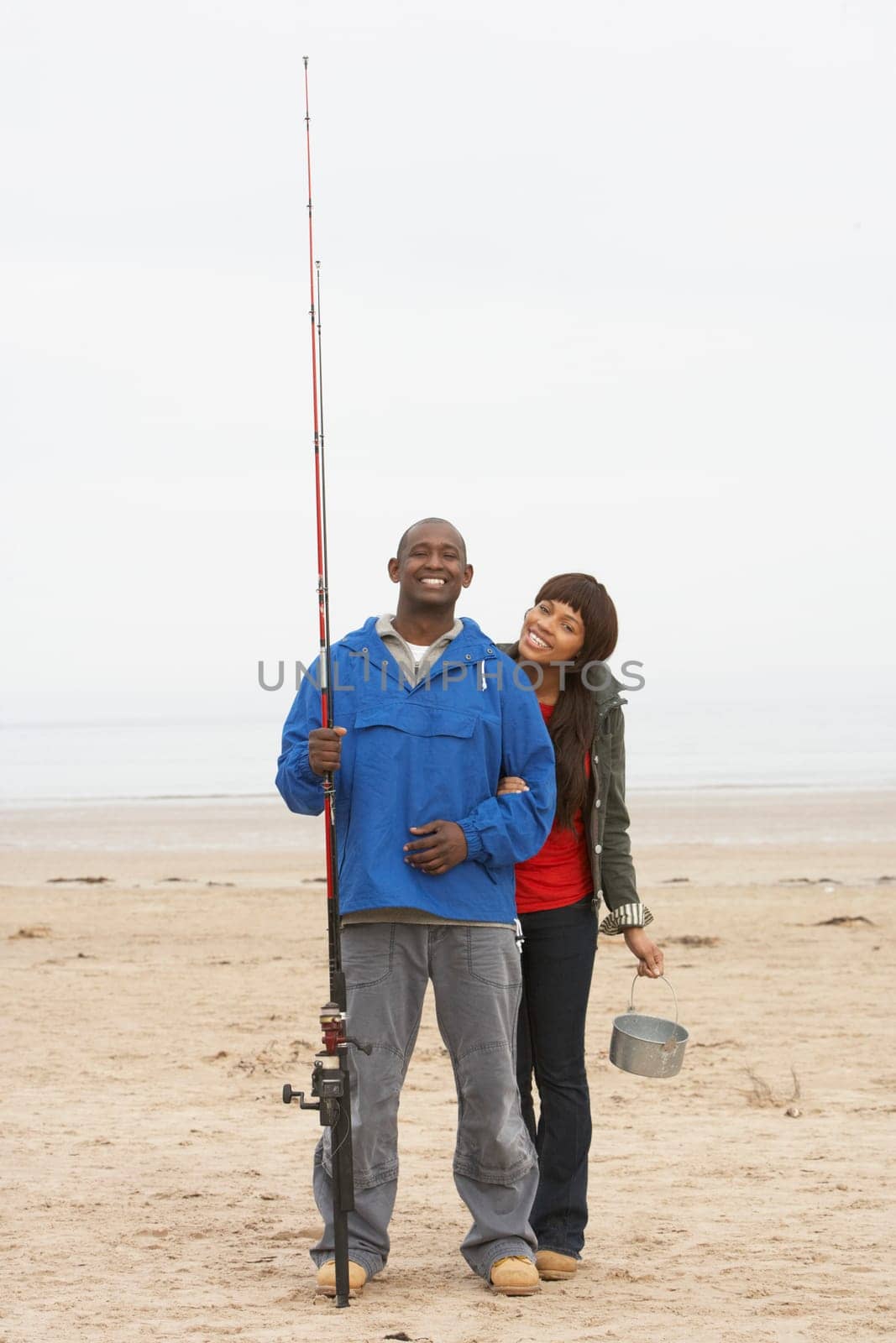 Couple Fishing On Beach