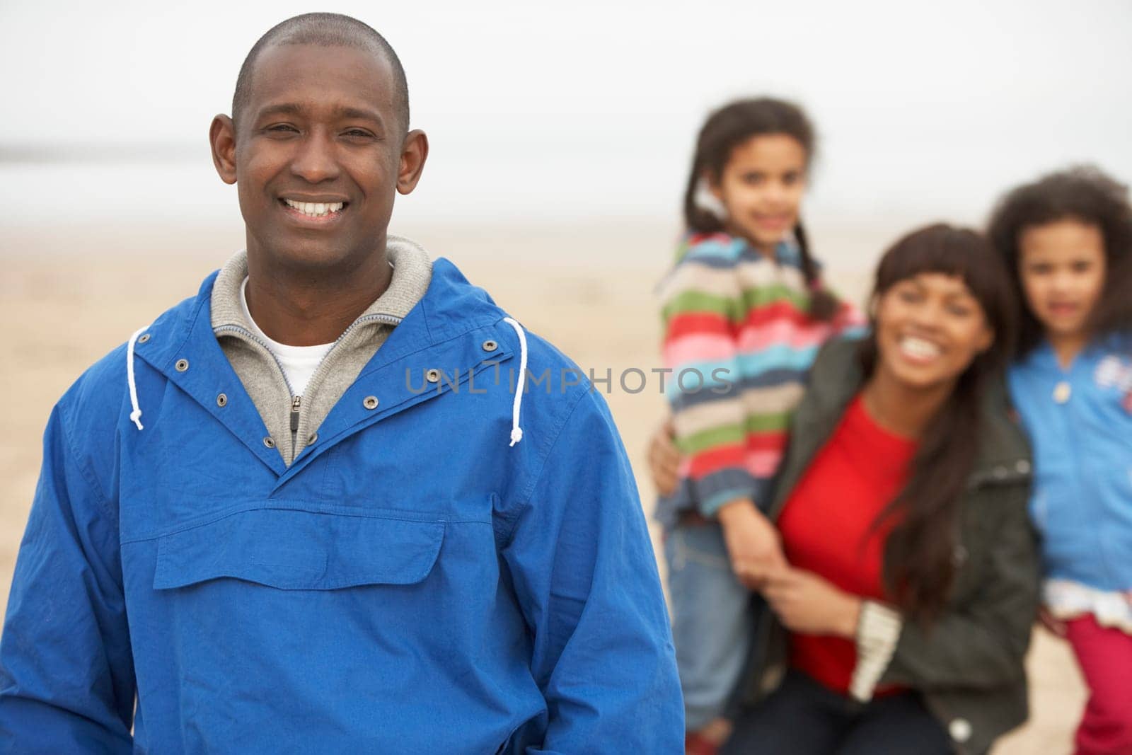 Family Relaxing On Winter Beach Break