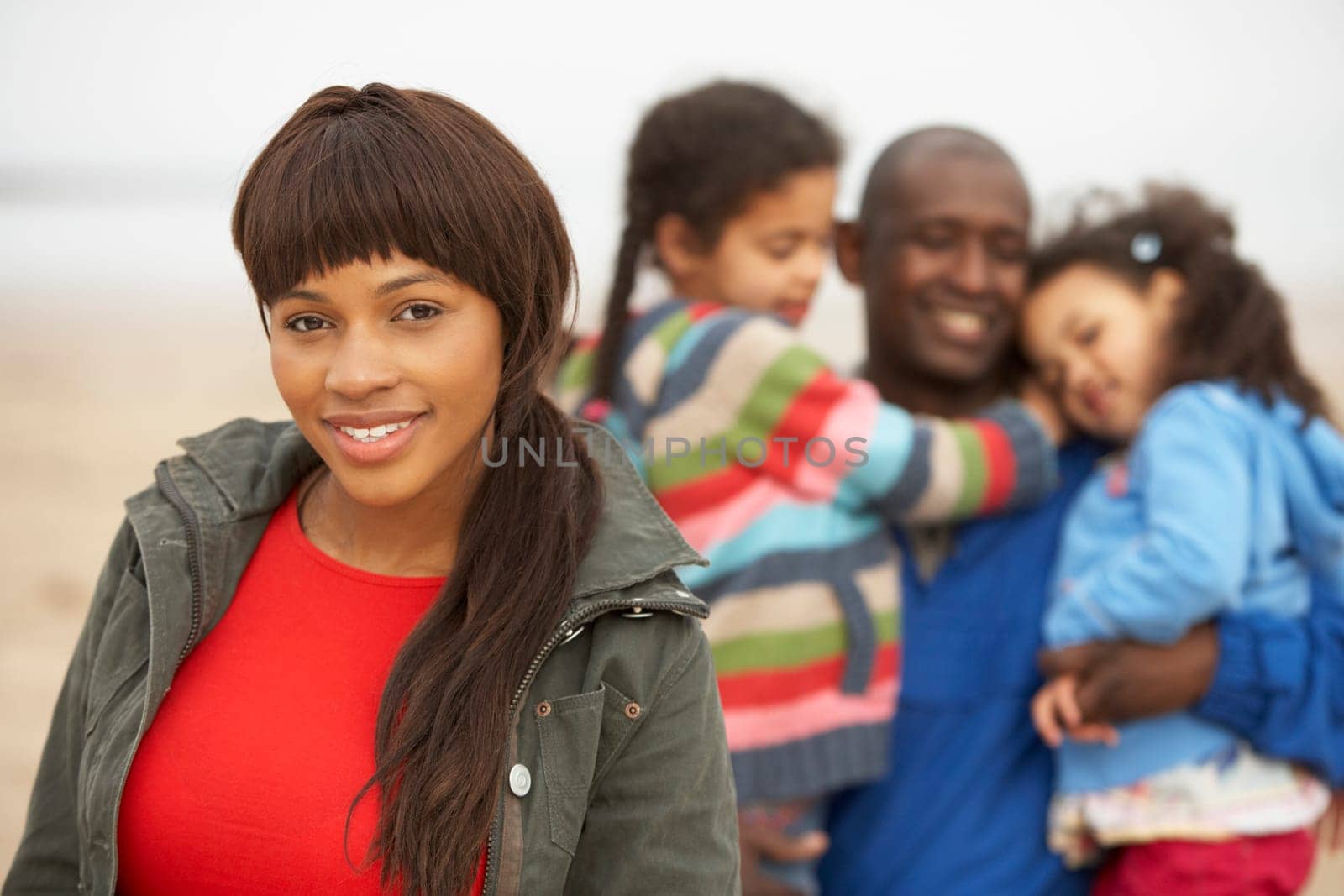 Family Relaxing On Winter Beach Break