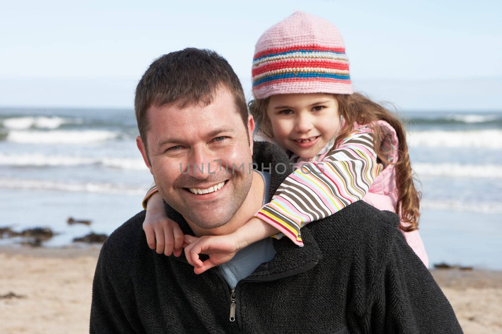 Father And Daughter Having Fun On Beach Together