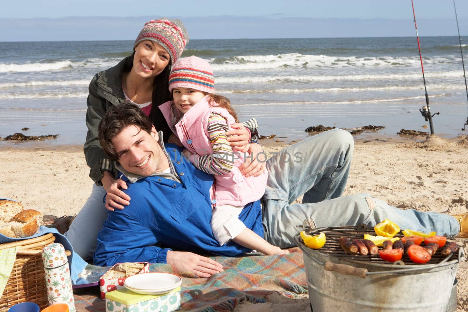 Family Having Barbeque On Winter Beach