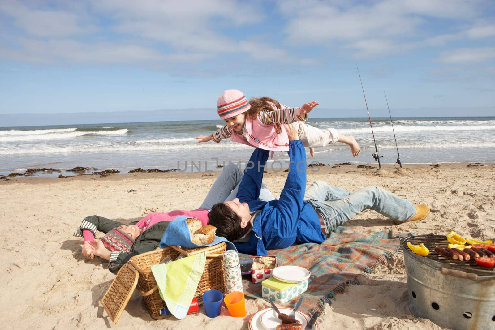 Family Having Barbeque On Winter Beach