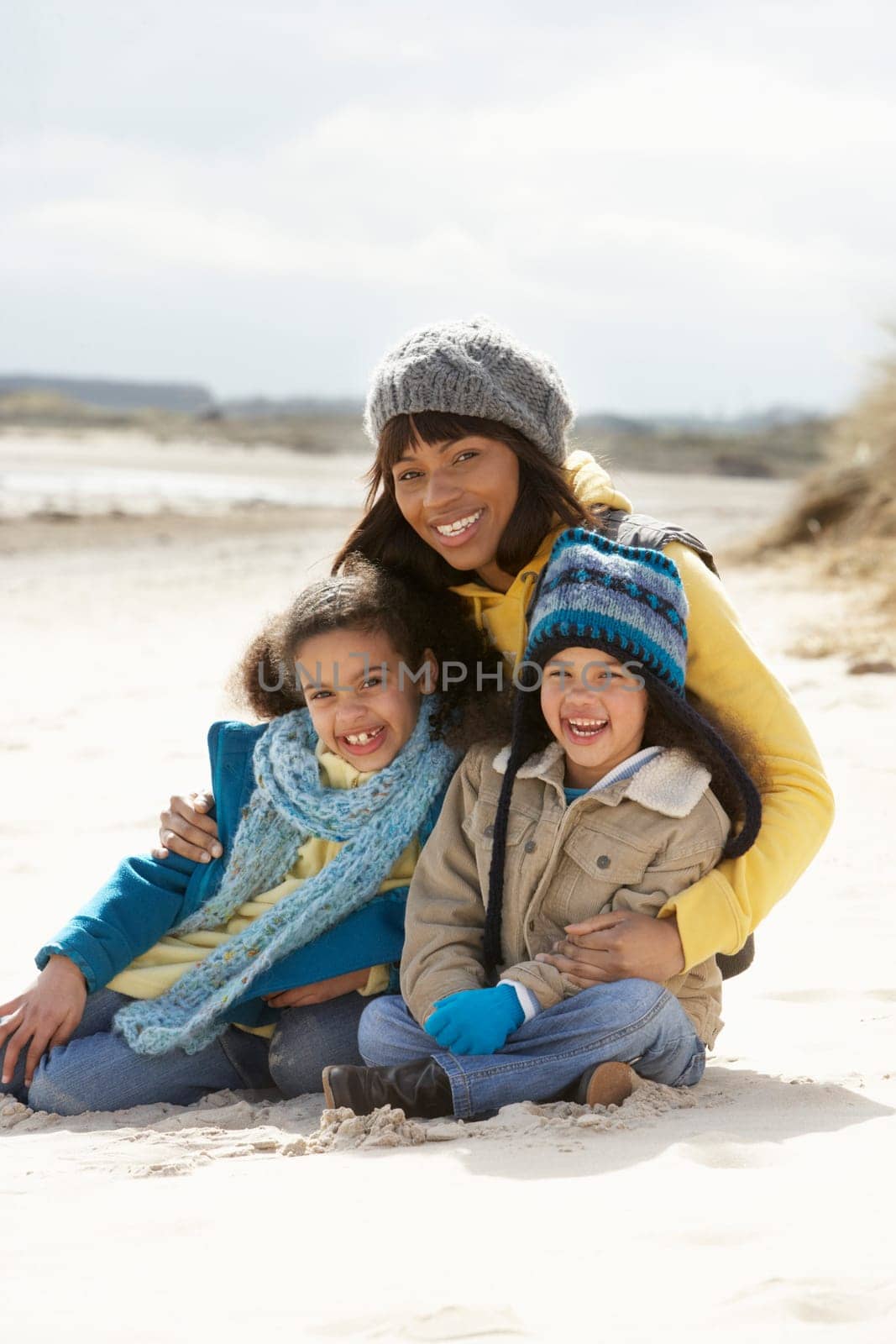 Mother And Children On Winter Beach