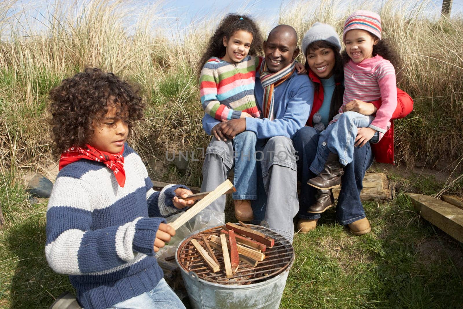Family Having Barbeque On Winter Beach