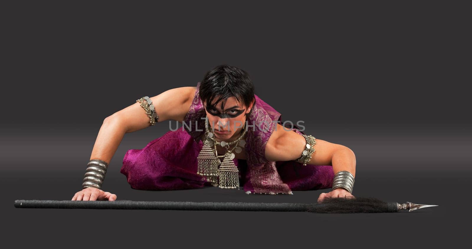Aggressive young man with spike - ready for fight - oriental costume