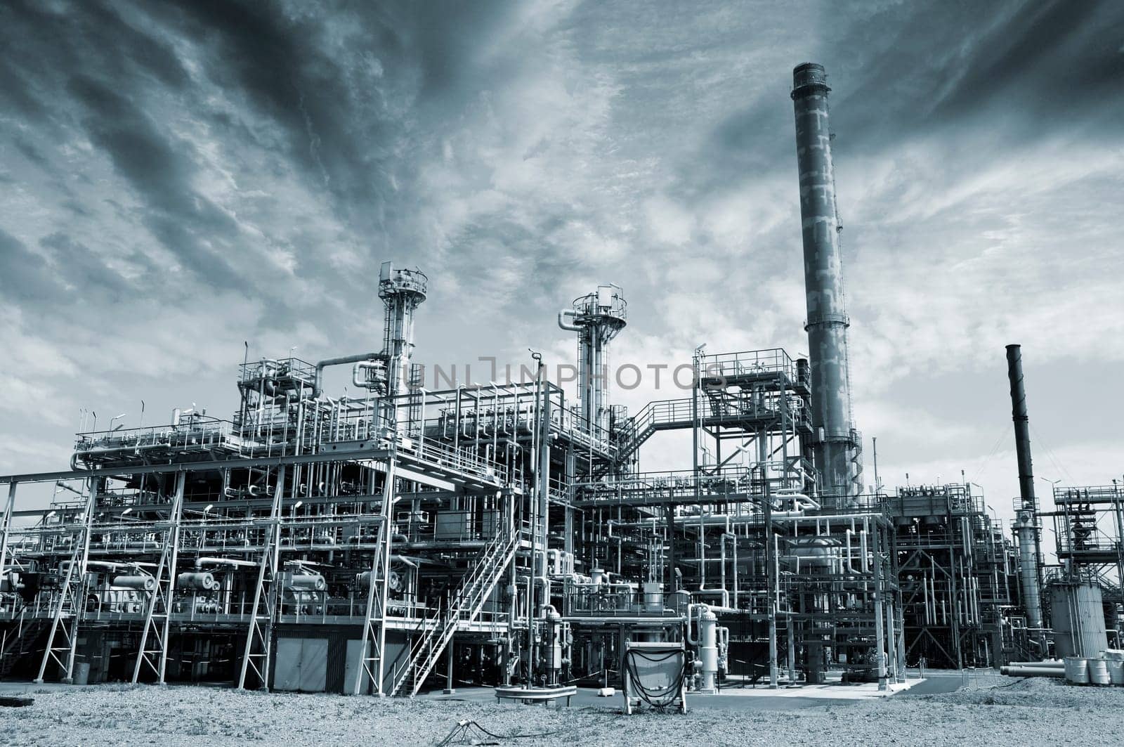 large oil and gas refinery, heavy toxic pollution and fog evaporating out in the air.