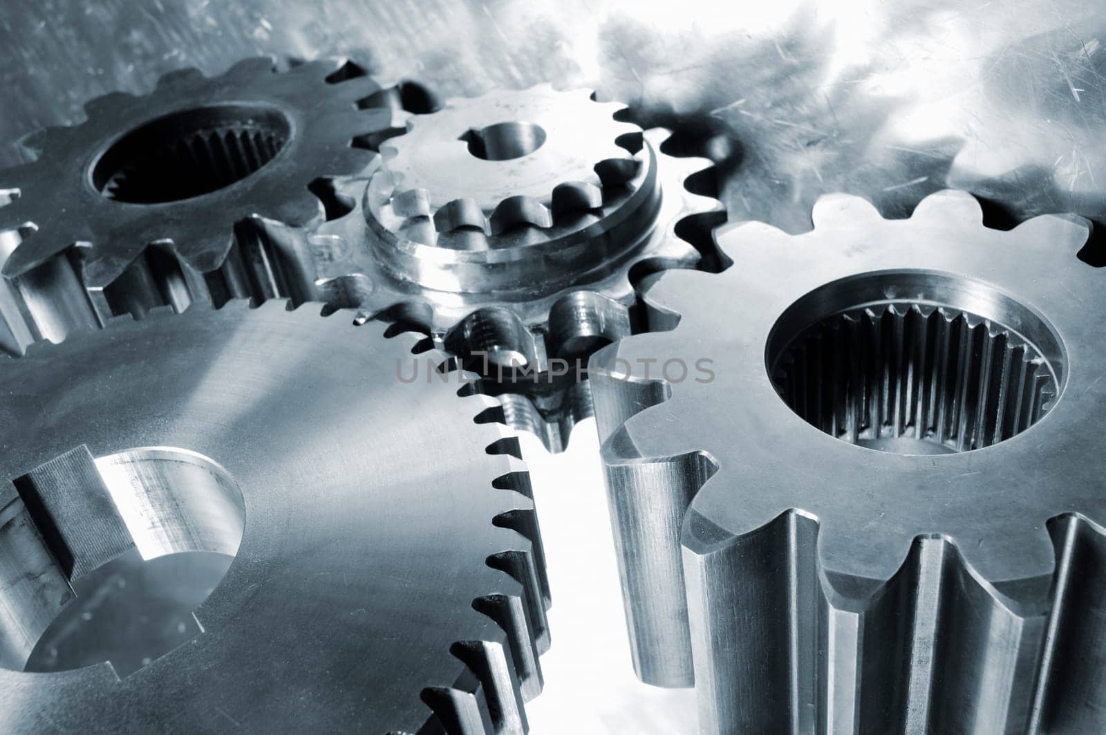 industrial titanium and steel gears mirrored in aluminum