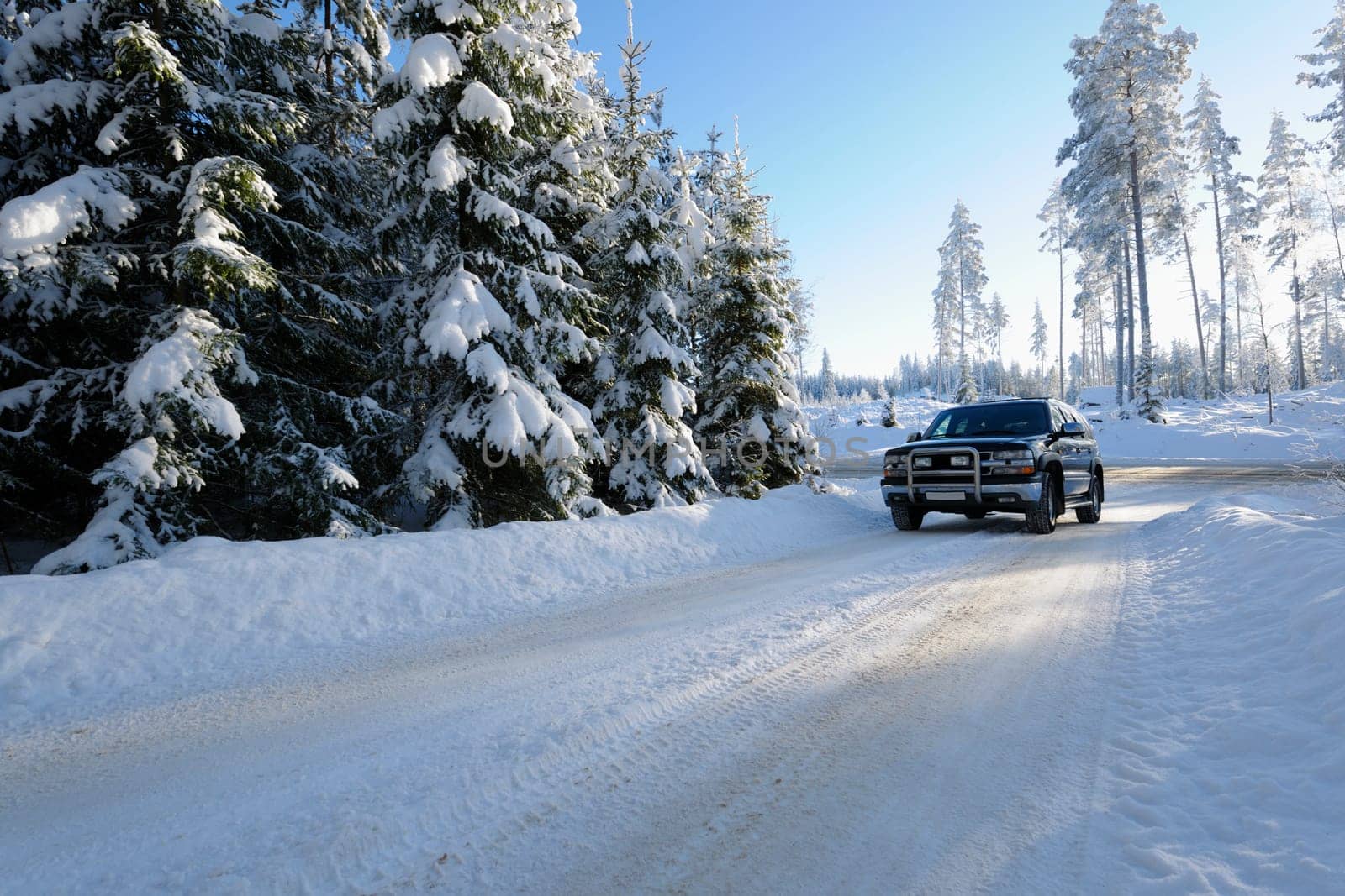 large suv, car, driving on snowy-road and a swedish winter landscape, ice and cold. own car, no trademarks