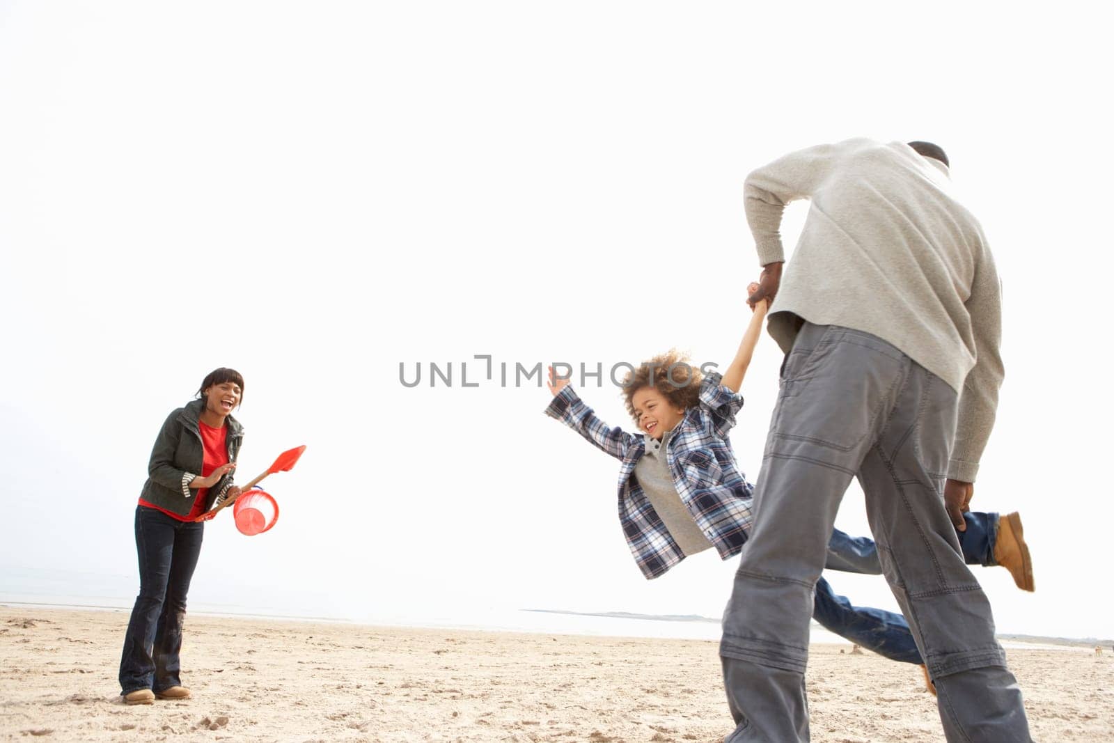 Young Family Relaxing On Beach Camping Holiday
