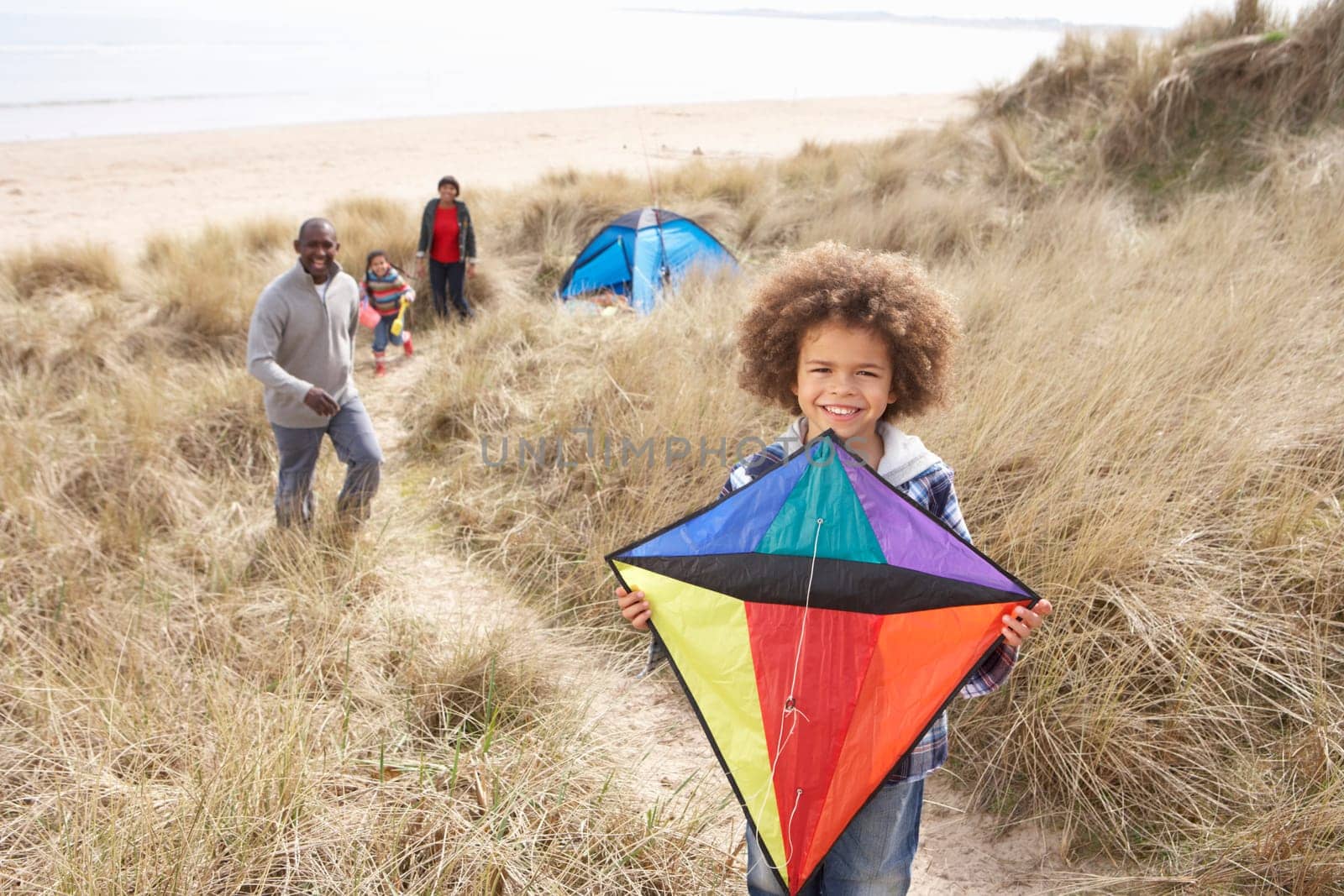Family Having Fun With Kite In Sand Dunes