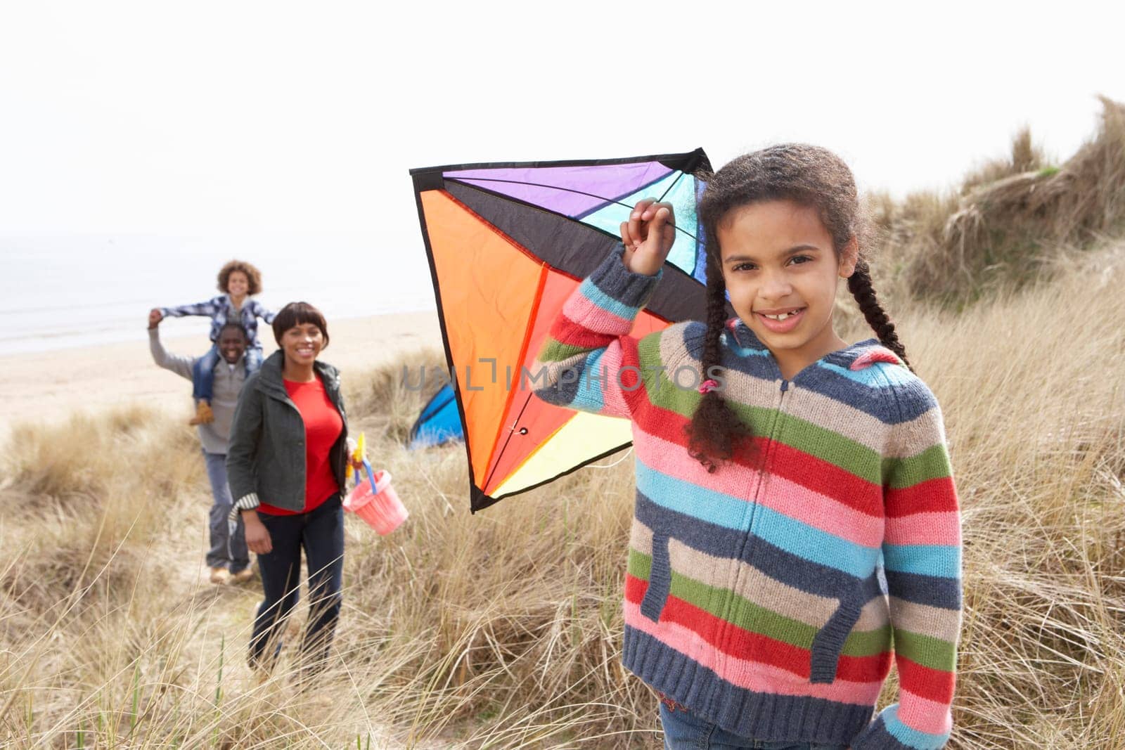 Family Having Fun With Kite In Sand Dunes