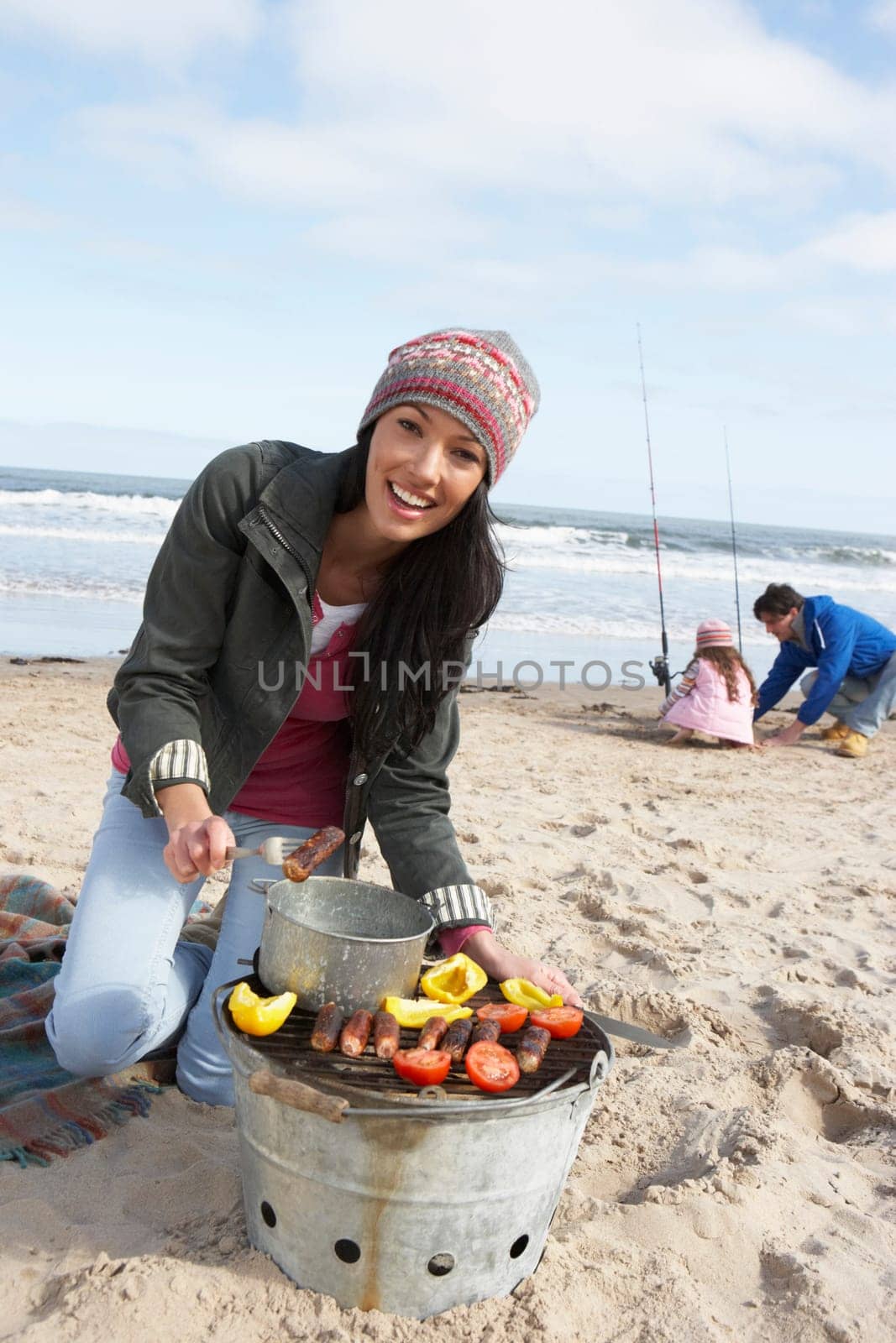 Family Having Barbeque On Winter Beach