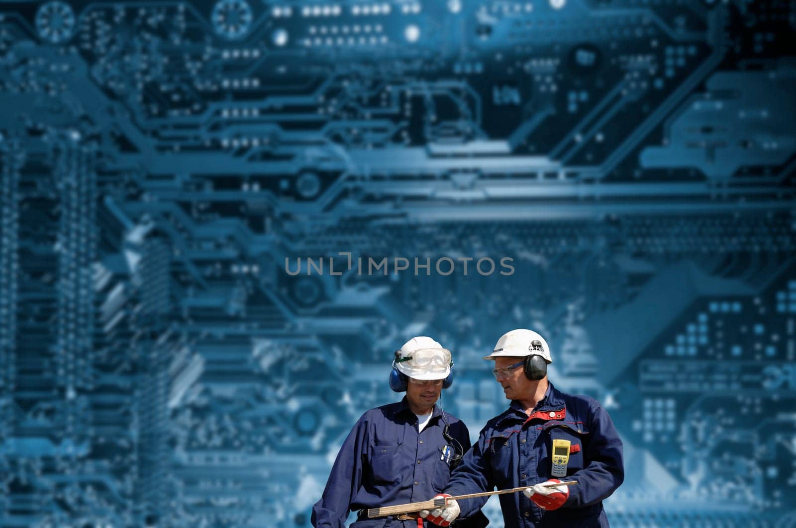 two engineers in front of computer circuitboard, associated with nuclear-power stations dashboard of controles.